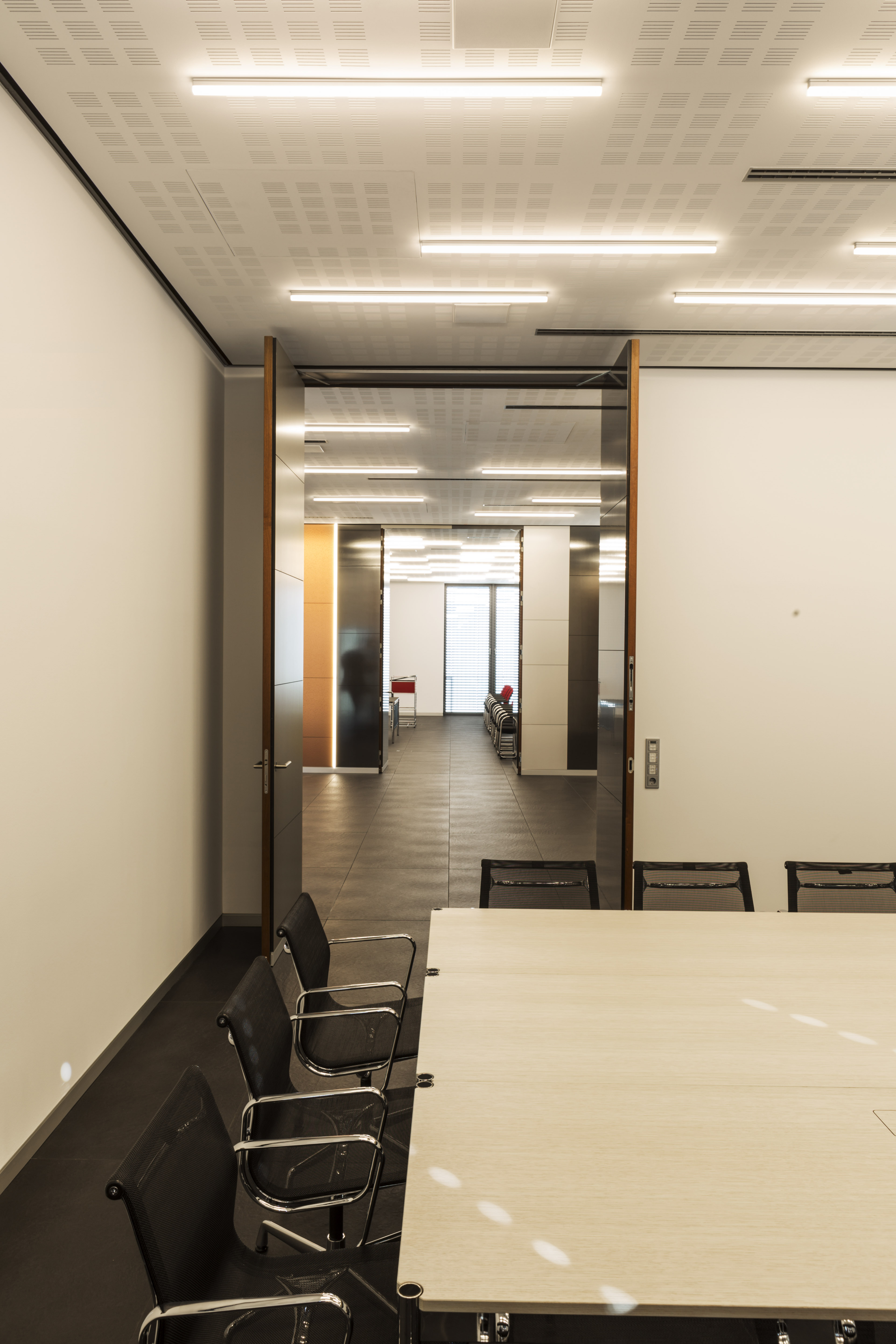 Dark tiled floor in a modern office and conference room.