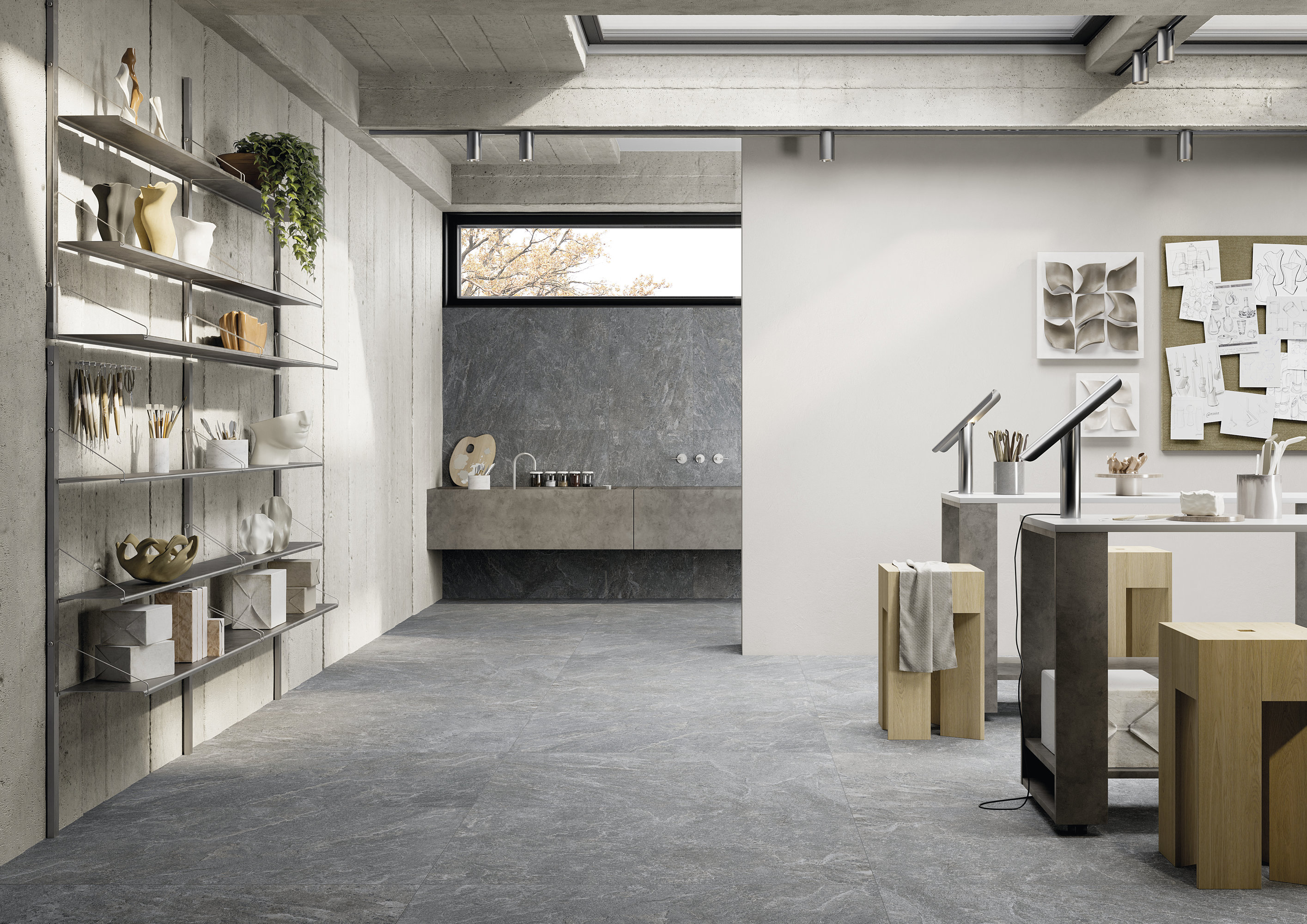 Concrete-effect tiles: Grey floor and wall tiles in a modern design studio.
