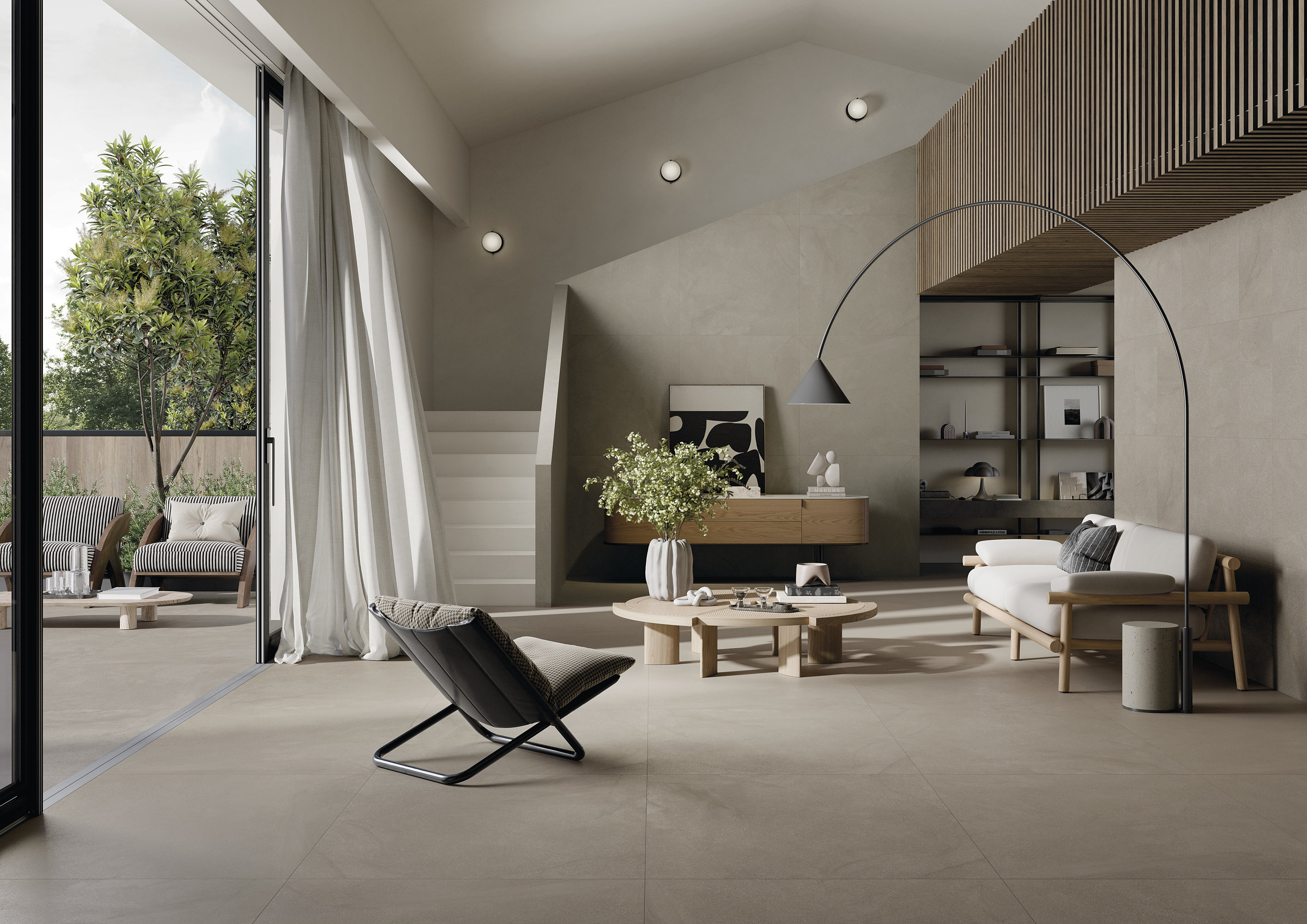 Bright, large-format tiles create a seamless transition between modern living room and terrace.