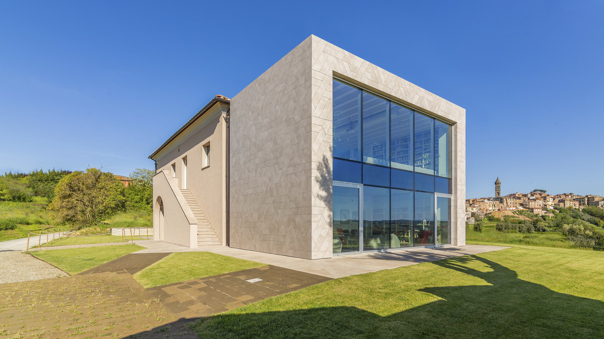 Modern building with bright tiled facade and large glass front, exterior view.