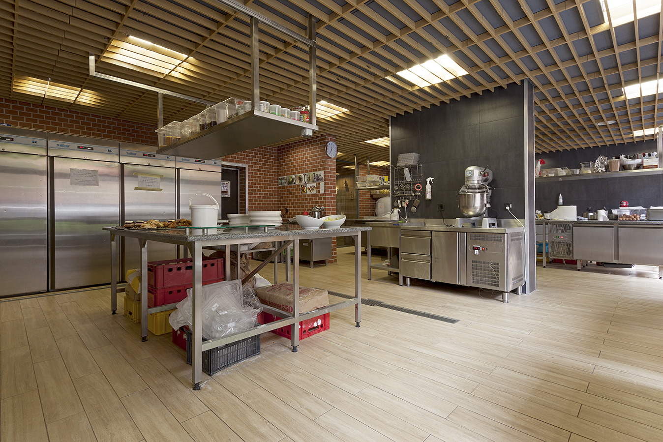 Stylish wood-look tile floor in a modern commercial kitchen.