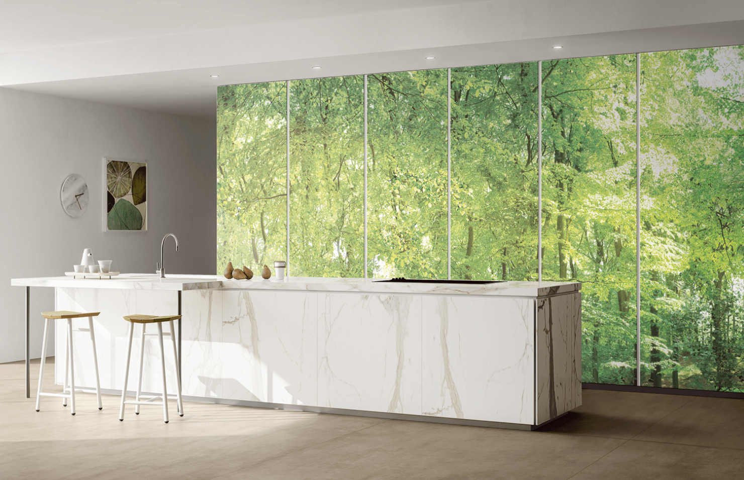 Bright kitchen with large format marble-effect tiles and forest view.