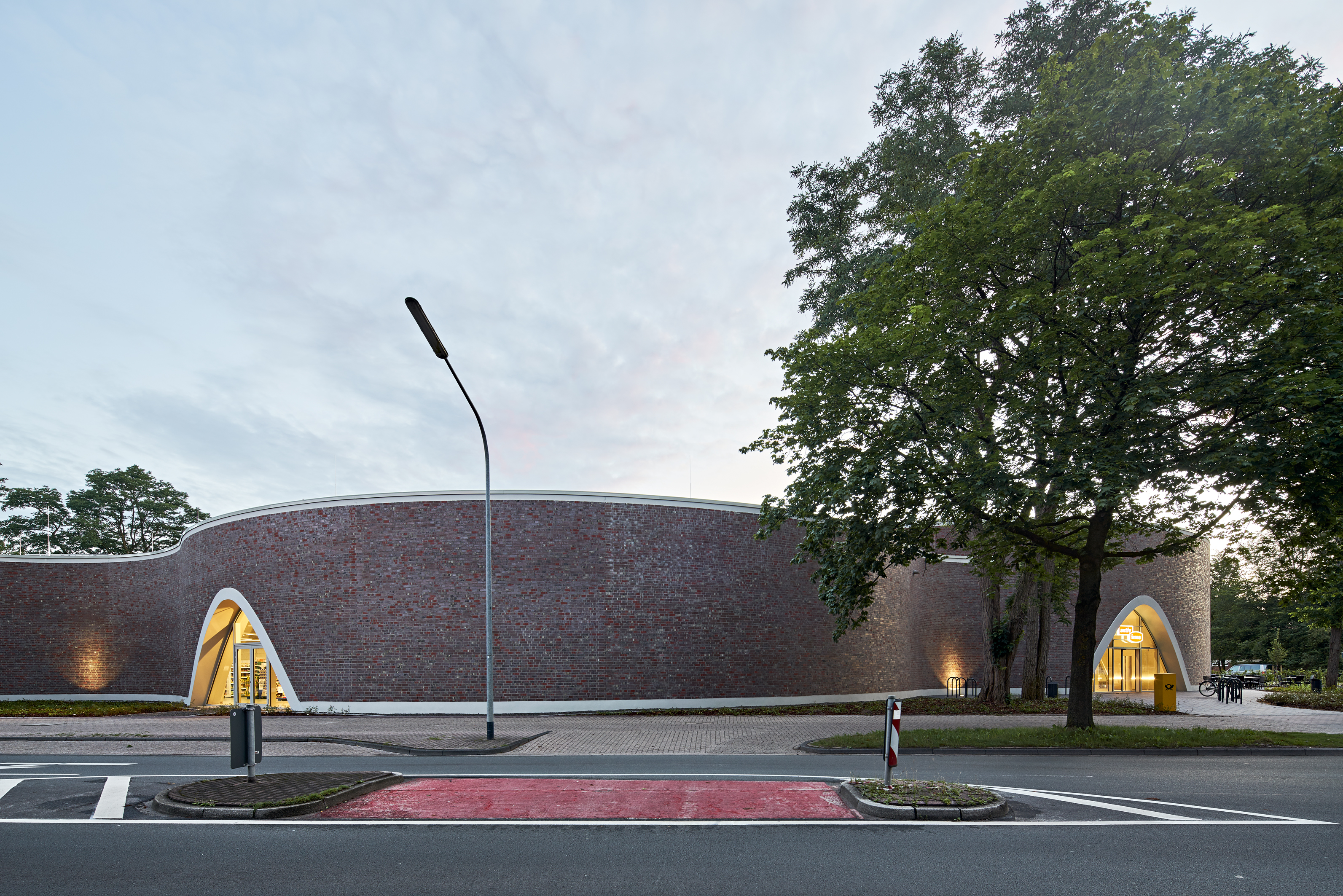 Modern Architecture: Curved brick facade with light arches.