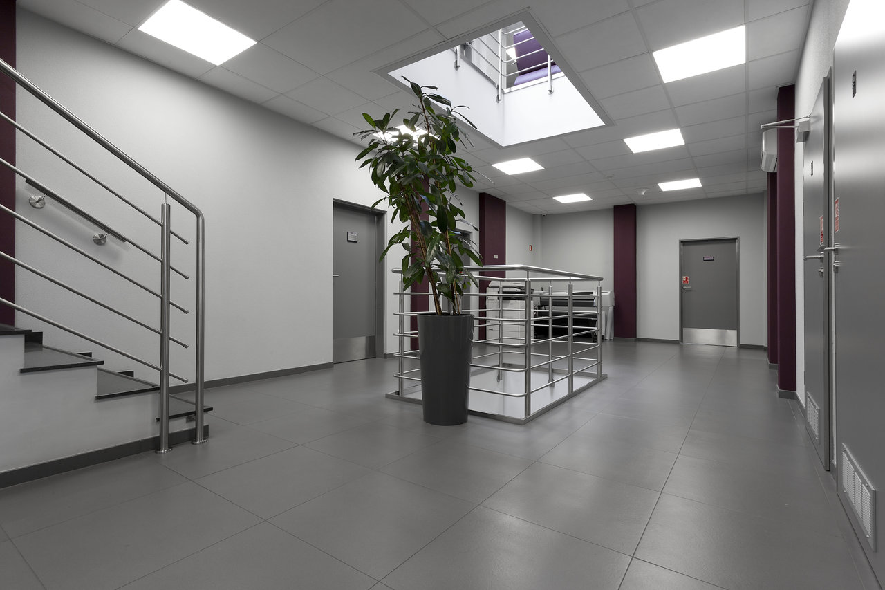 Contemporary hallway with robust grey tiles, ideal for commercial or residential use.
