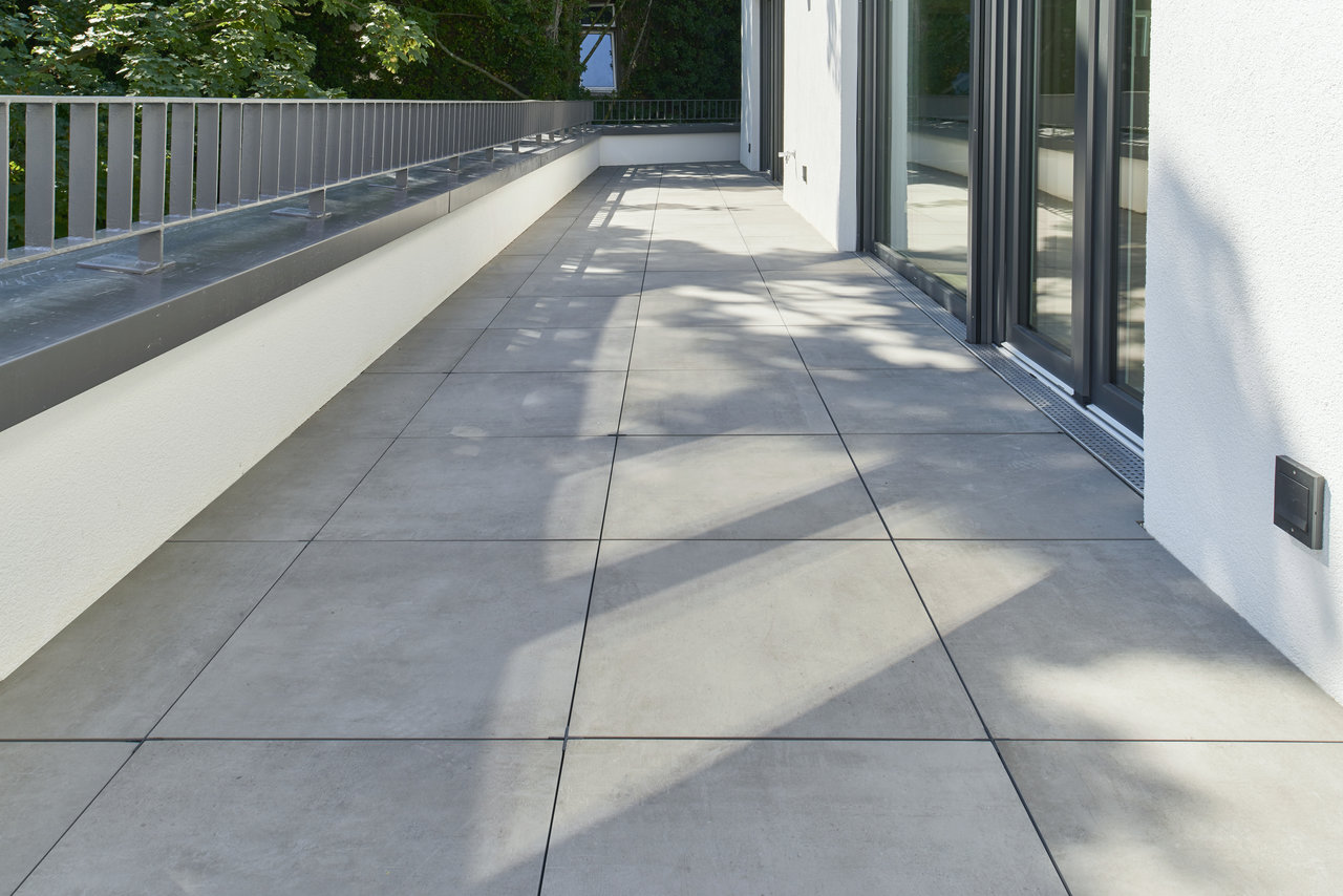 High-quality grey outdoor tiles on a sunny terrace.