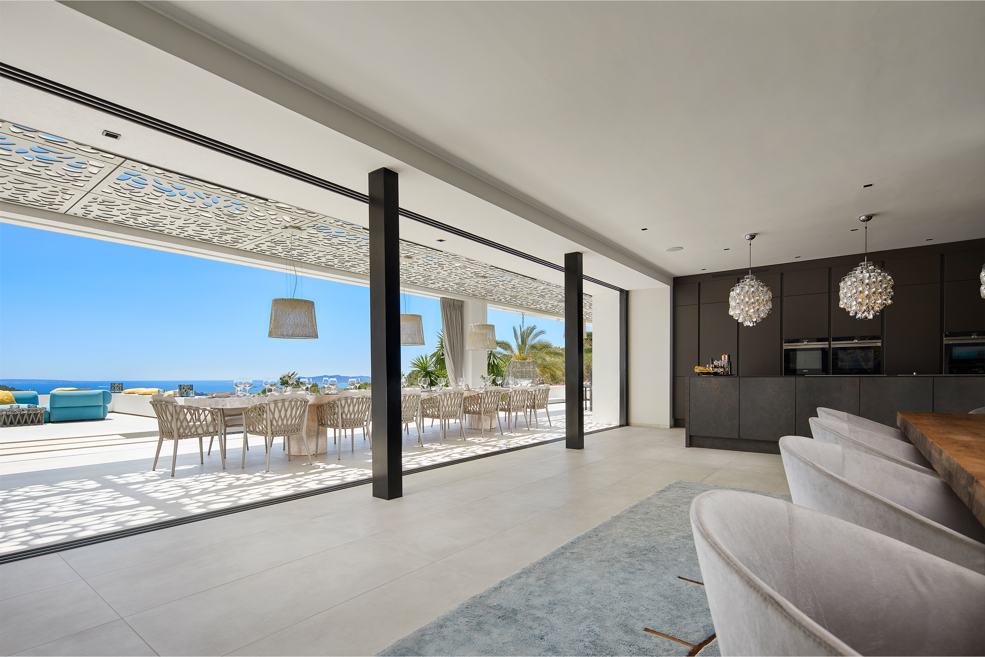 Luxurious living space with Porcelaingres tiles, opening to a terrace with sea view.