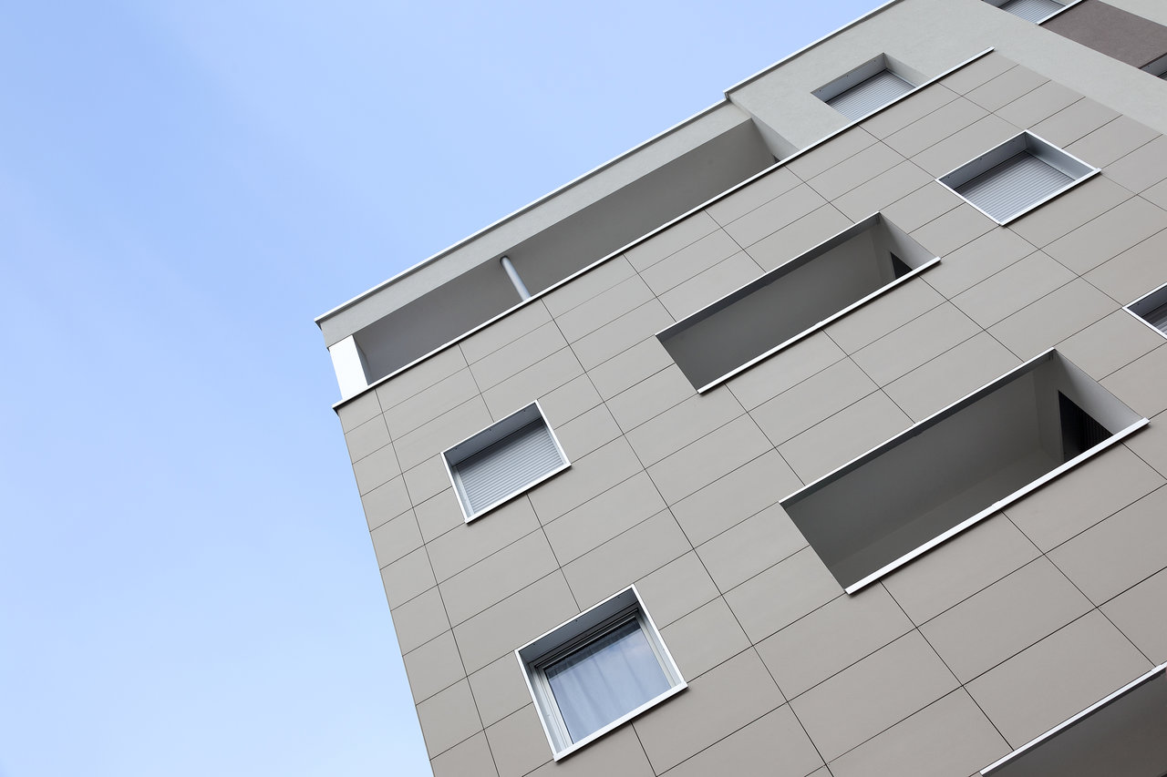 Contemporary building facade with high-quality grey outdoor tiles.