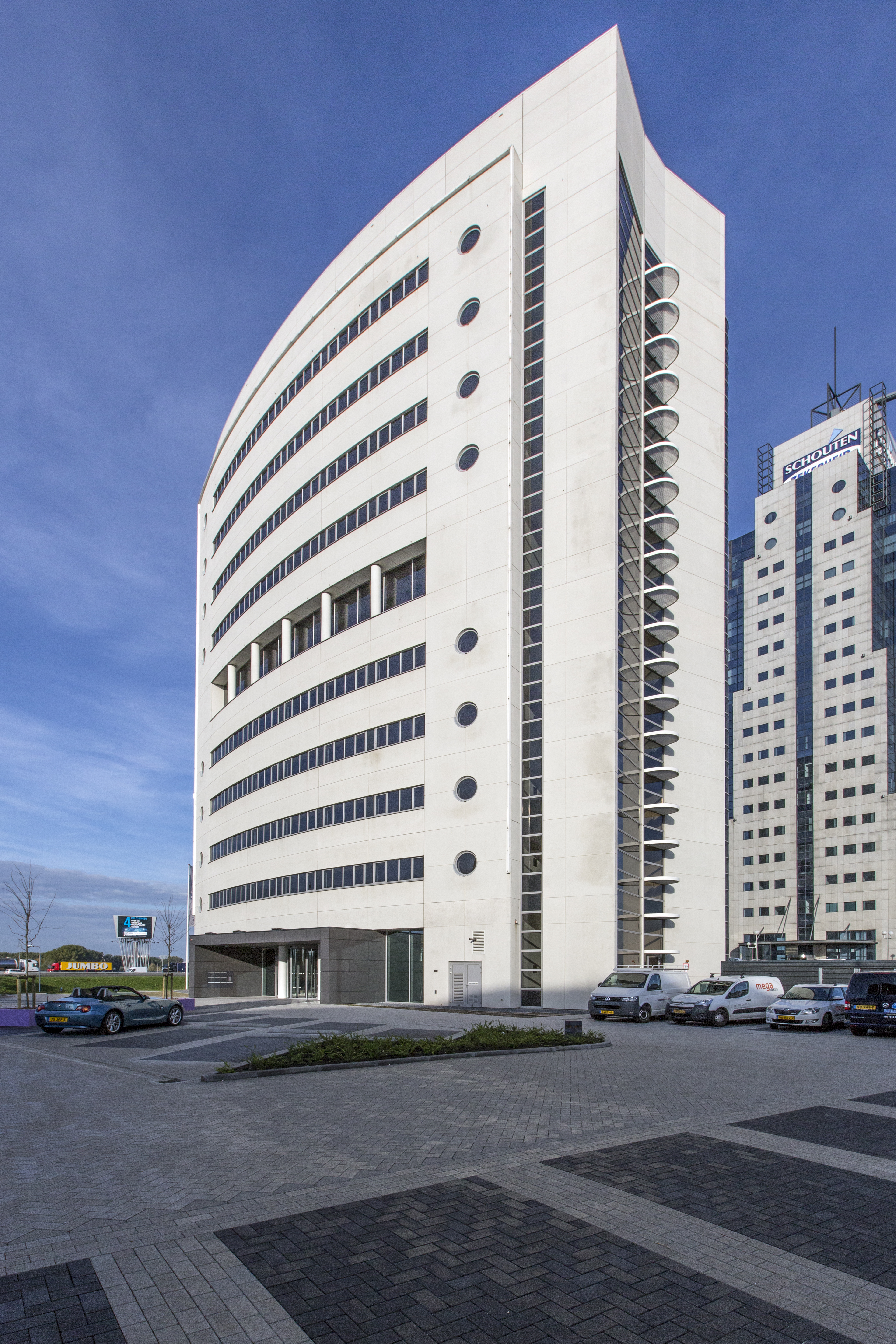 Modern building with an outdoor tiled forecourt.