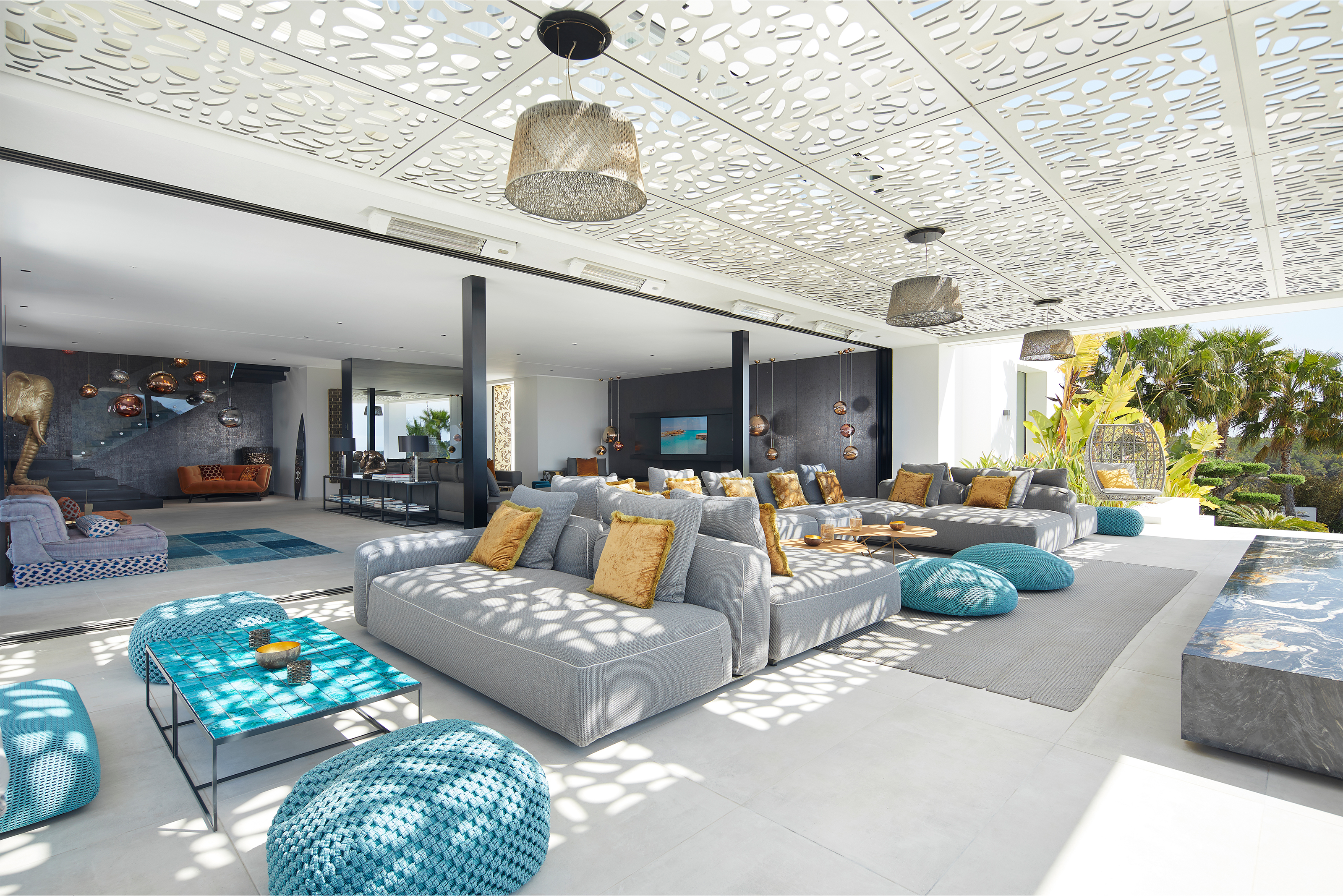Spacious indoor-outdoor living area with bright tiles and stylish decor.