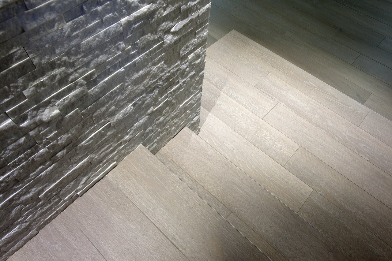 Grey stone-effect wall tiles and light wood-effect floor tiles.