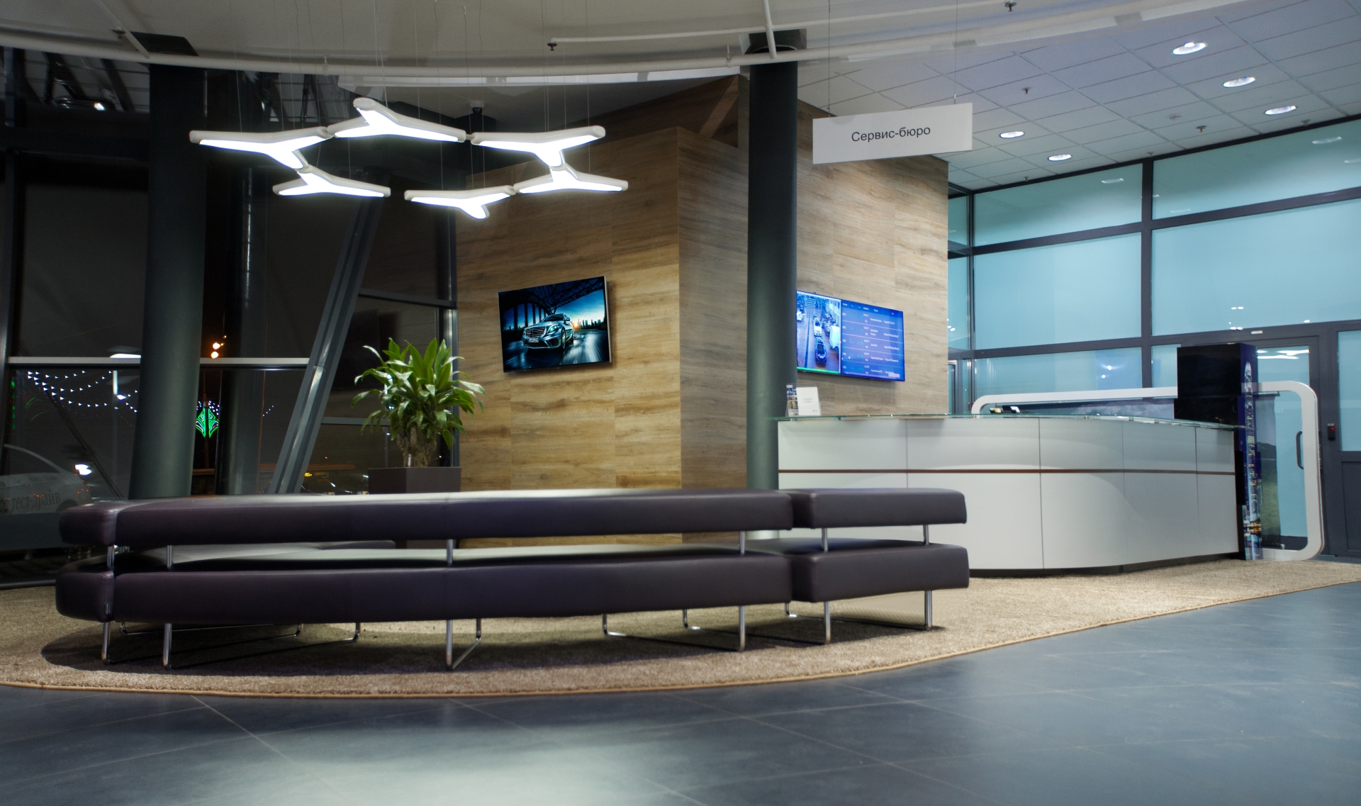 Elegant lobby with dark floor tiles, comfortable seating, and modern lighting.