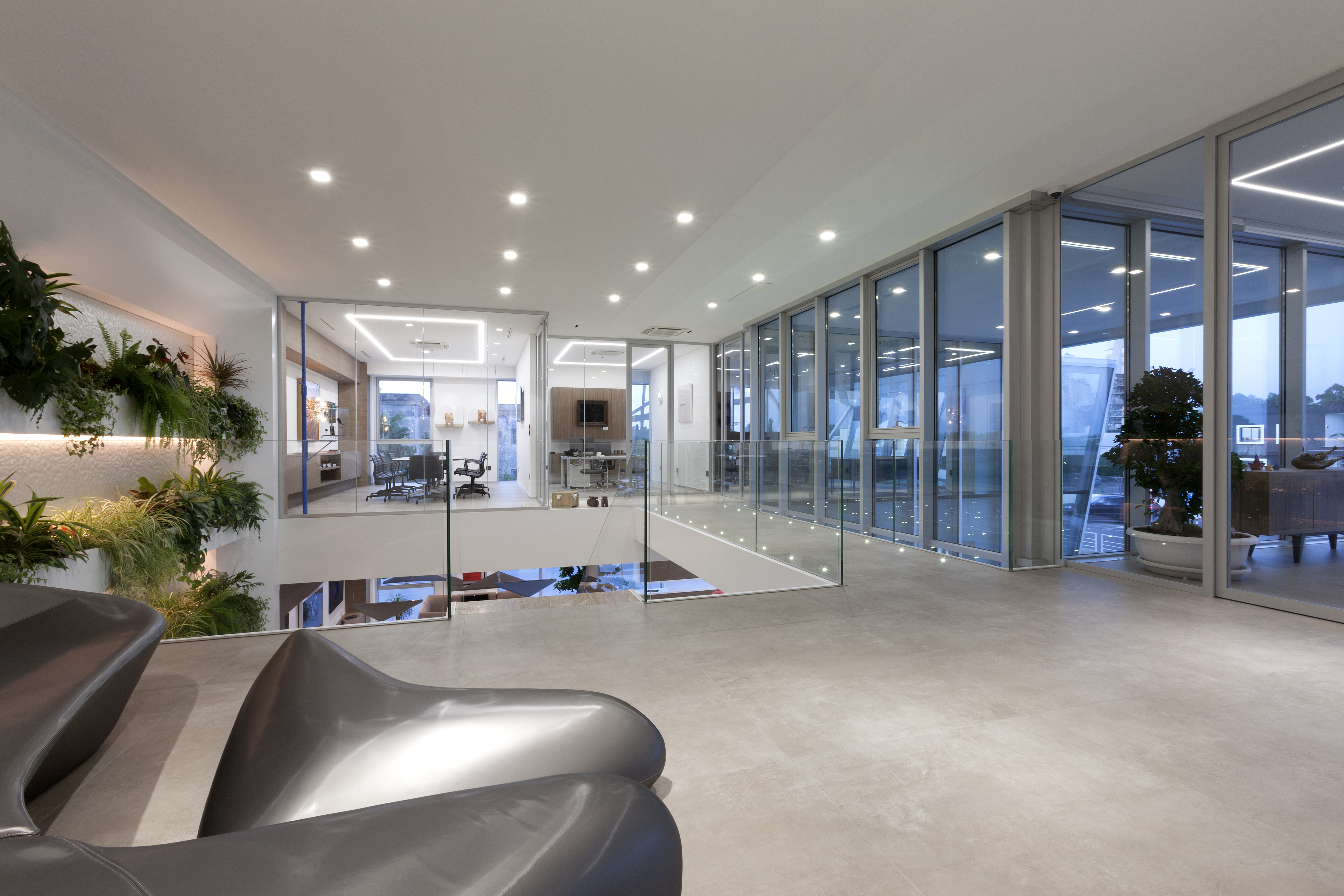 Spacious, bright room with modern floor tiles, glass fronts, and vertical greenery.
