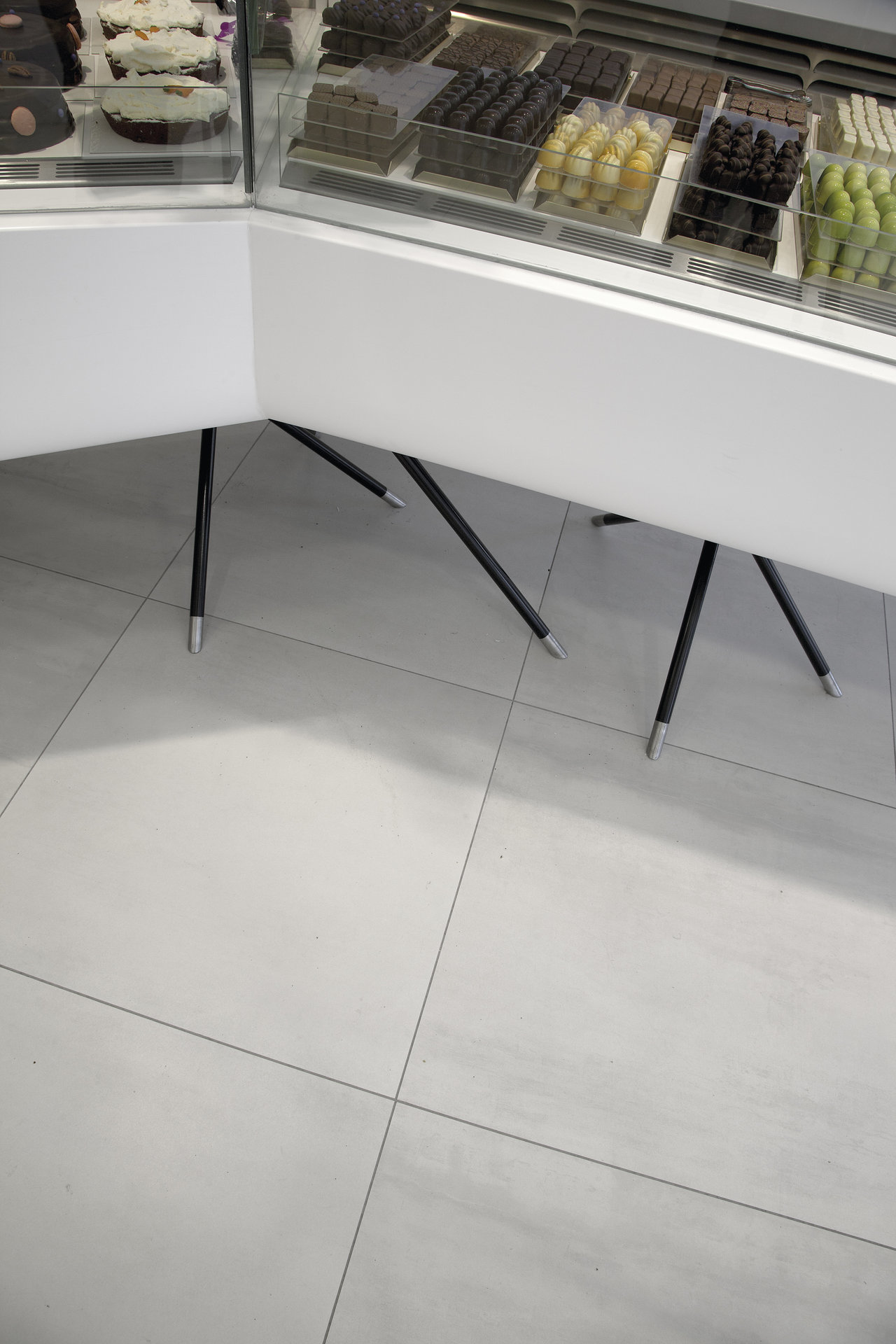 Modern, light grey Porcelaingres floor tiles in a shop.
