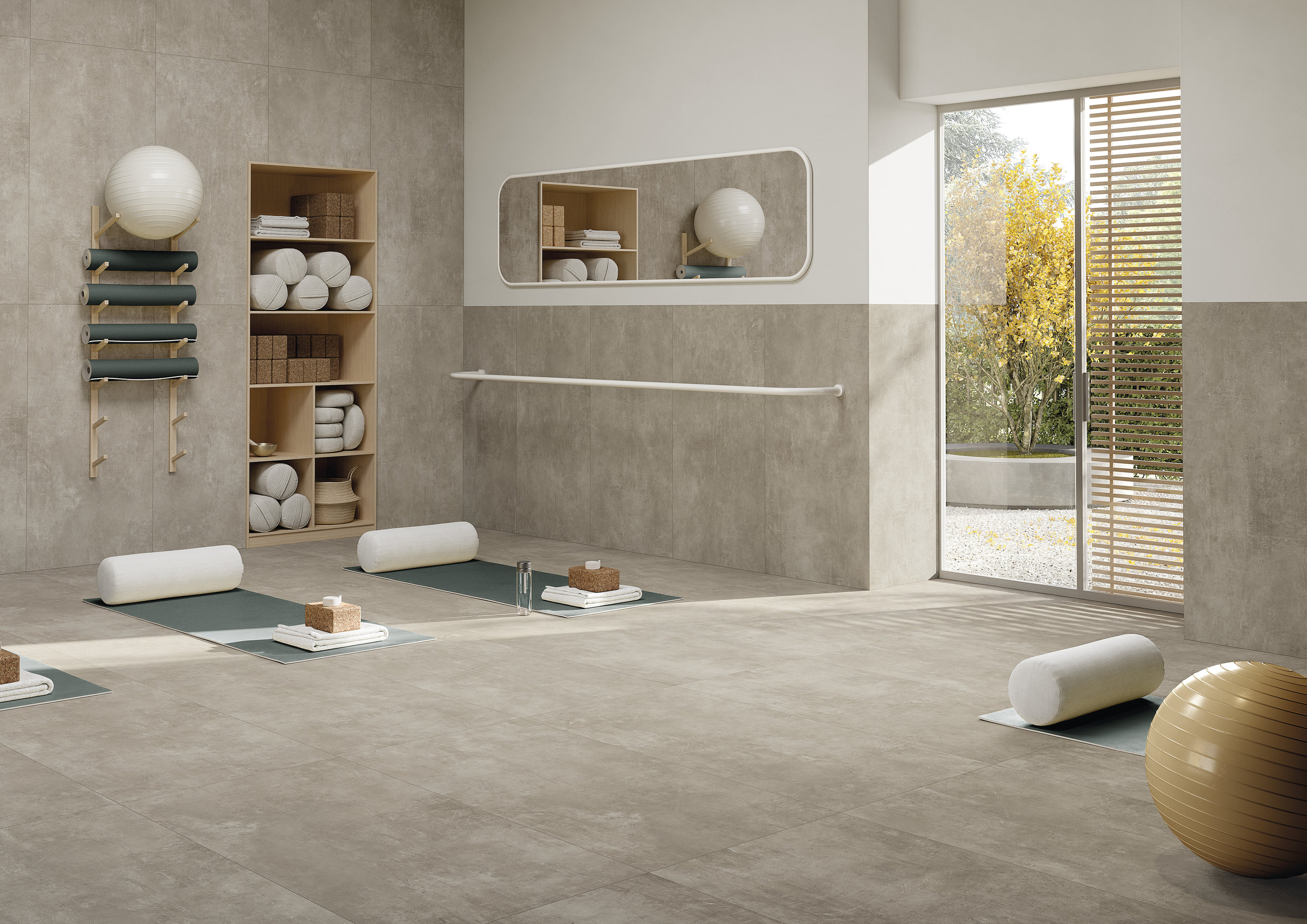 Bright yoga room with high-quality concrete-effect tiles on floor and walls.