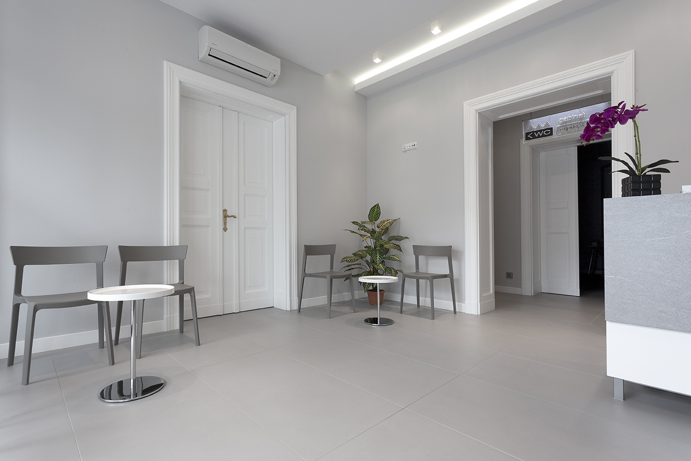 Modern waiting area with elegant, light grey floor tiles.