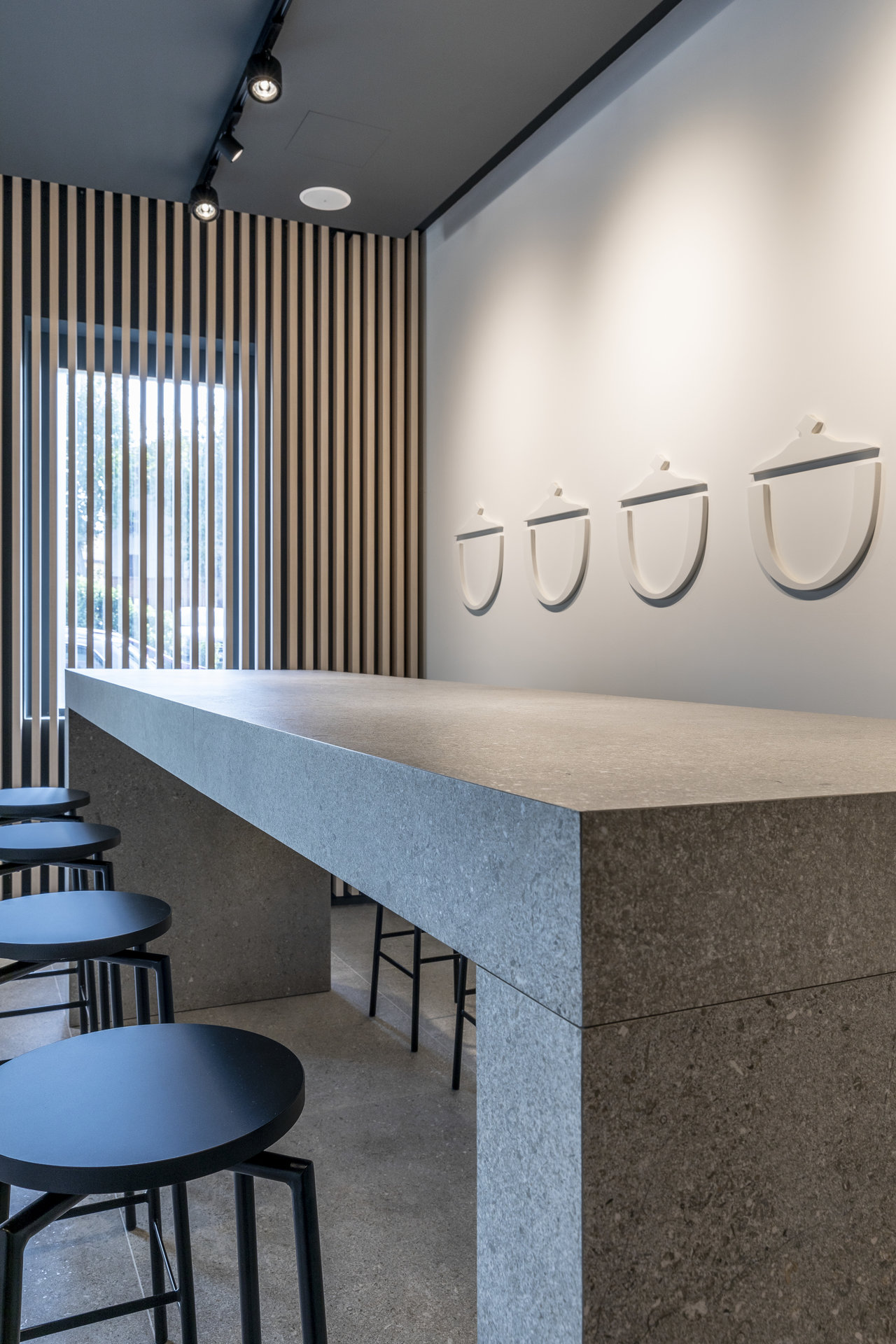 High-quality grey stone-effect tiles as counter and floor in a modern interior.