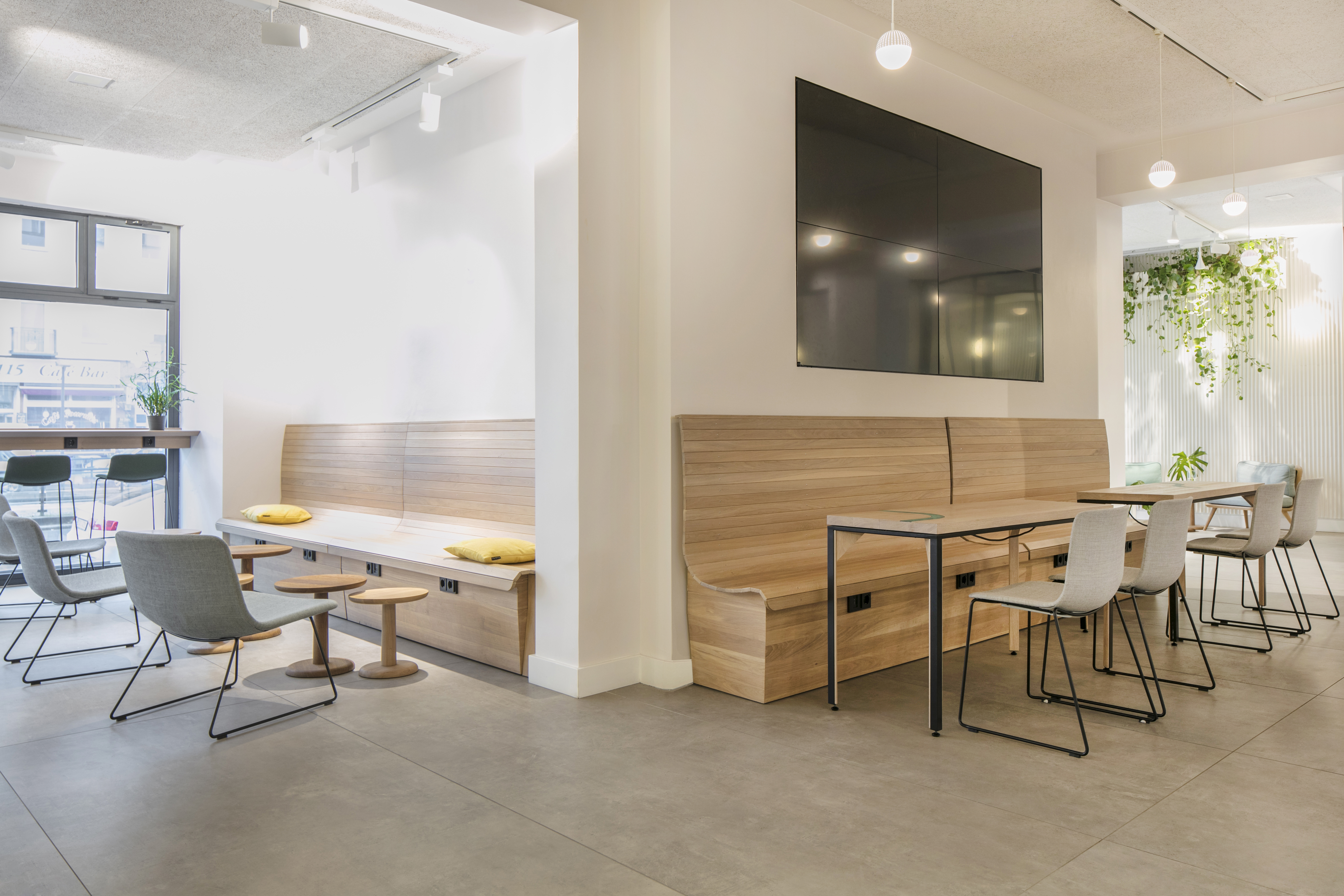 Bright, modern interior with high-quality grey floor tiles and seating.