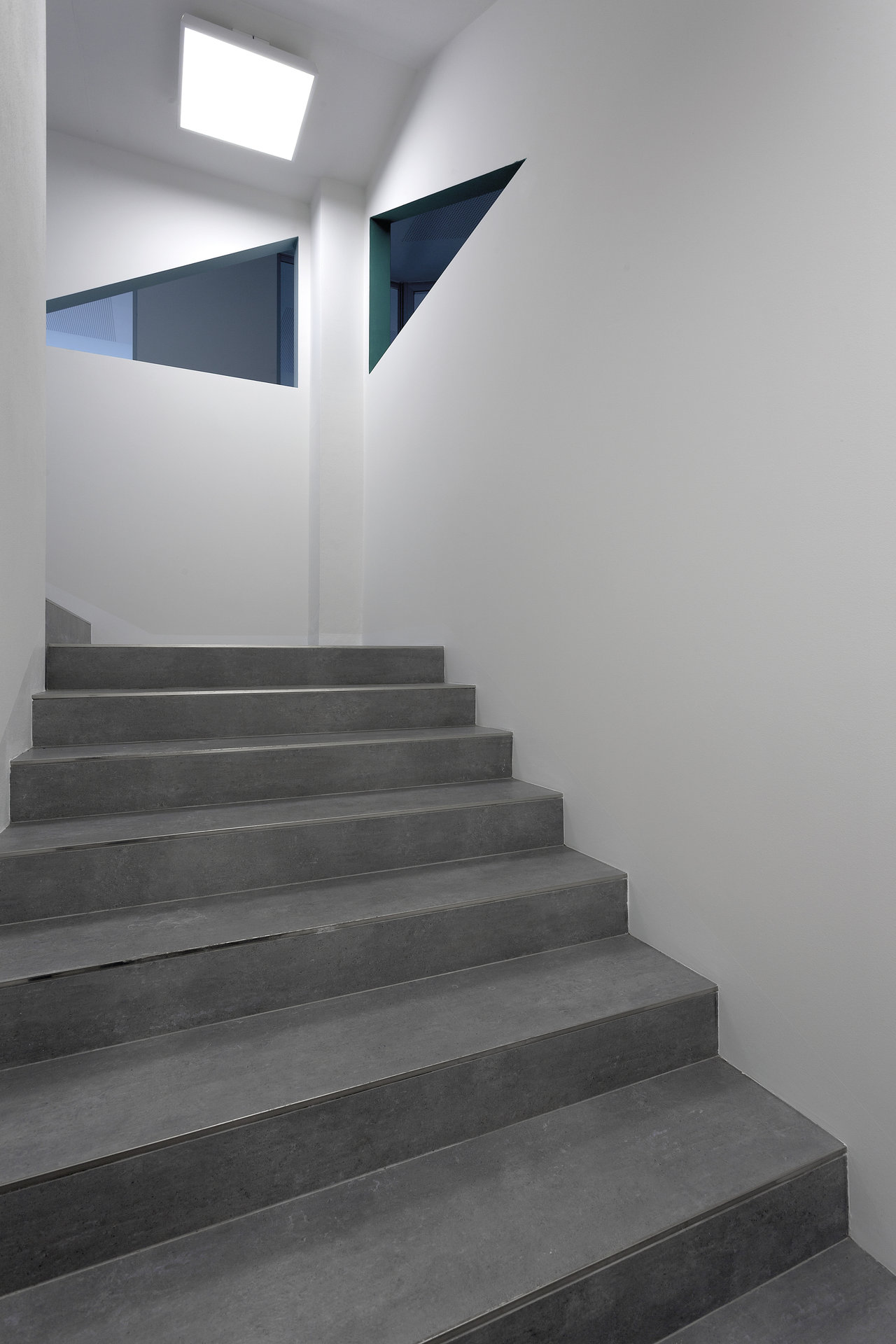 High-quality dark grey tiles on a modern staircase.