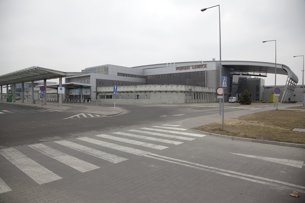 Airport terminal with access road and zebra crossing.