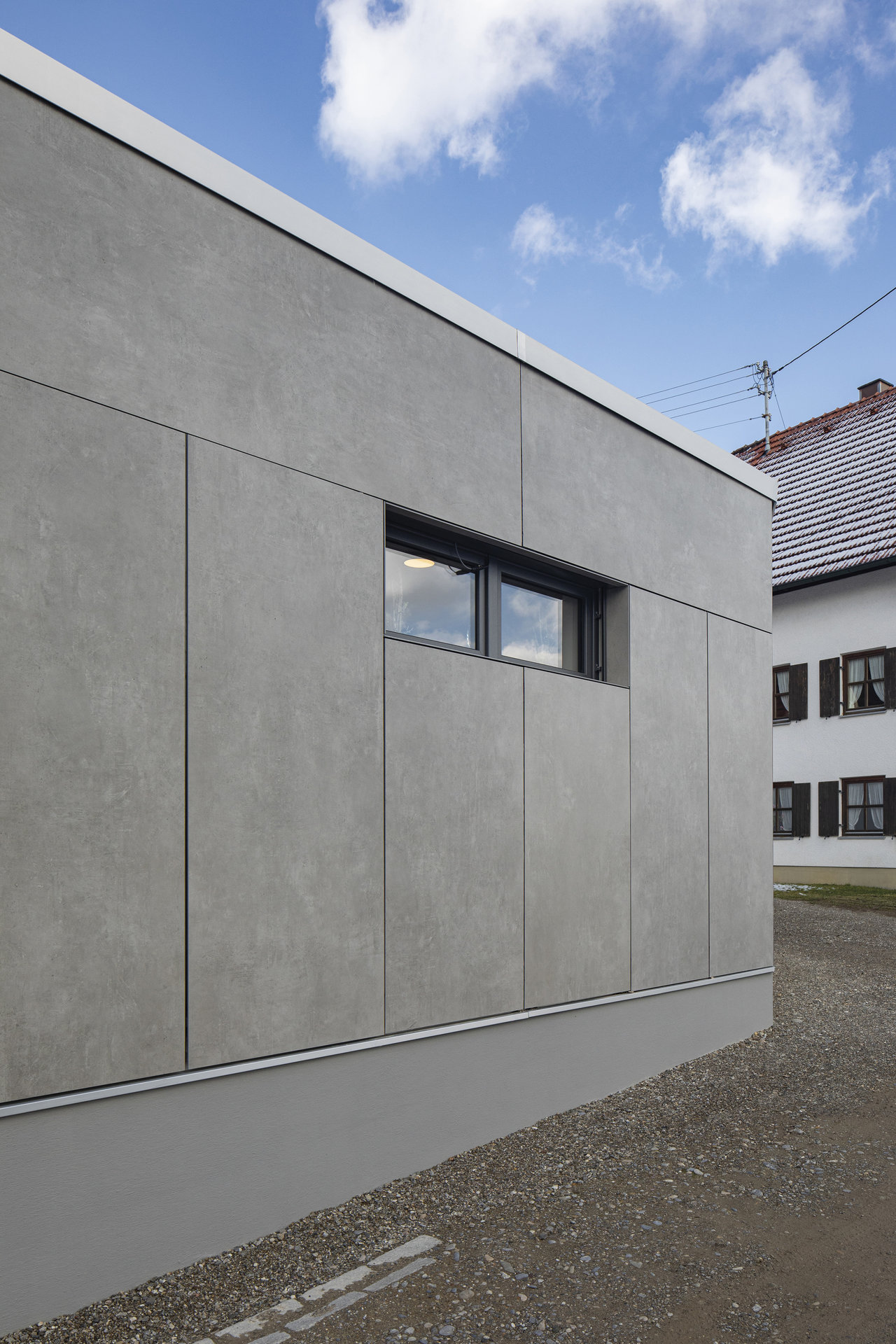 Modern facade with large-format grey outdoor tiles.