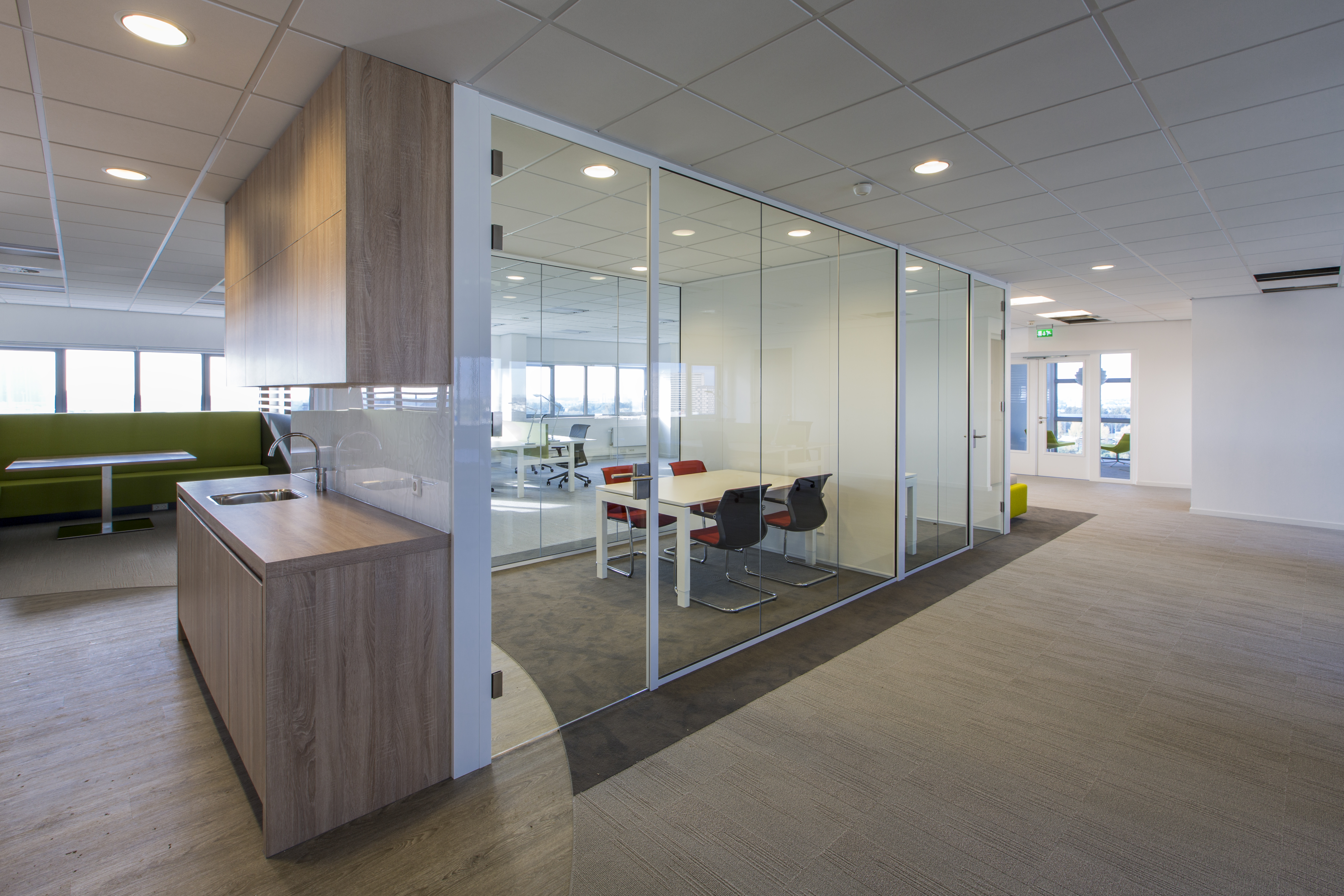 Appealing office design with varied flooring: carpet and wood-look tiles.