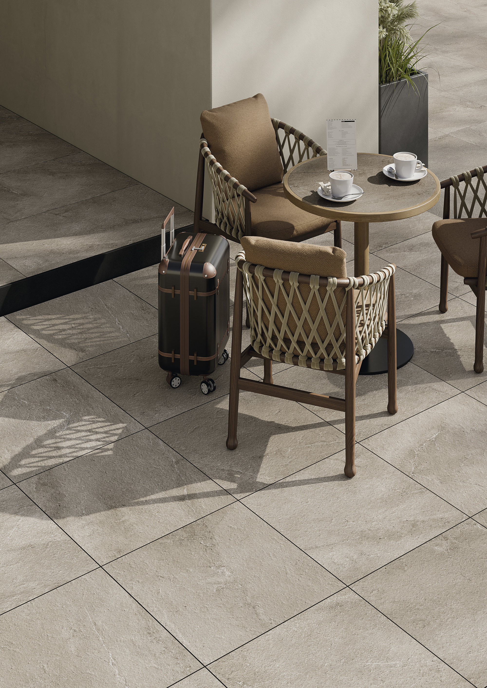 Premium light beige-grey outdoor tiles on a stylish terrace with seating.