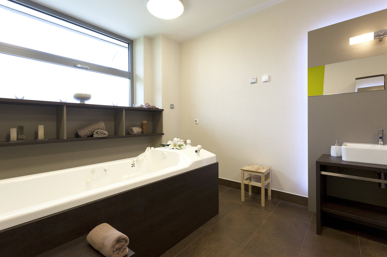 High-quality floor tiles in a modern spa bath with tub and vanity.