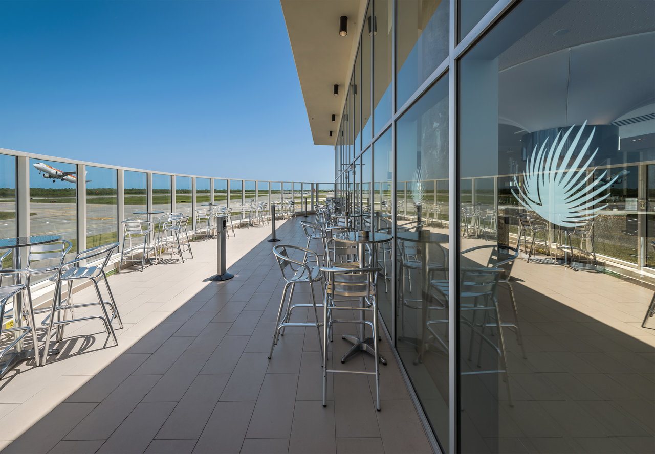 Bright, large-format outdoor tiles on a modern airport terrace.