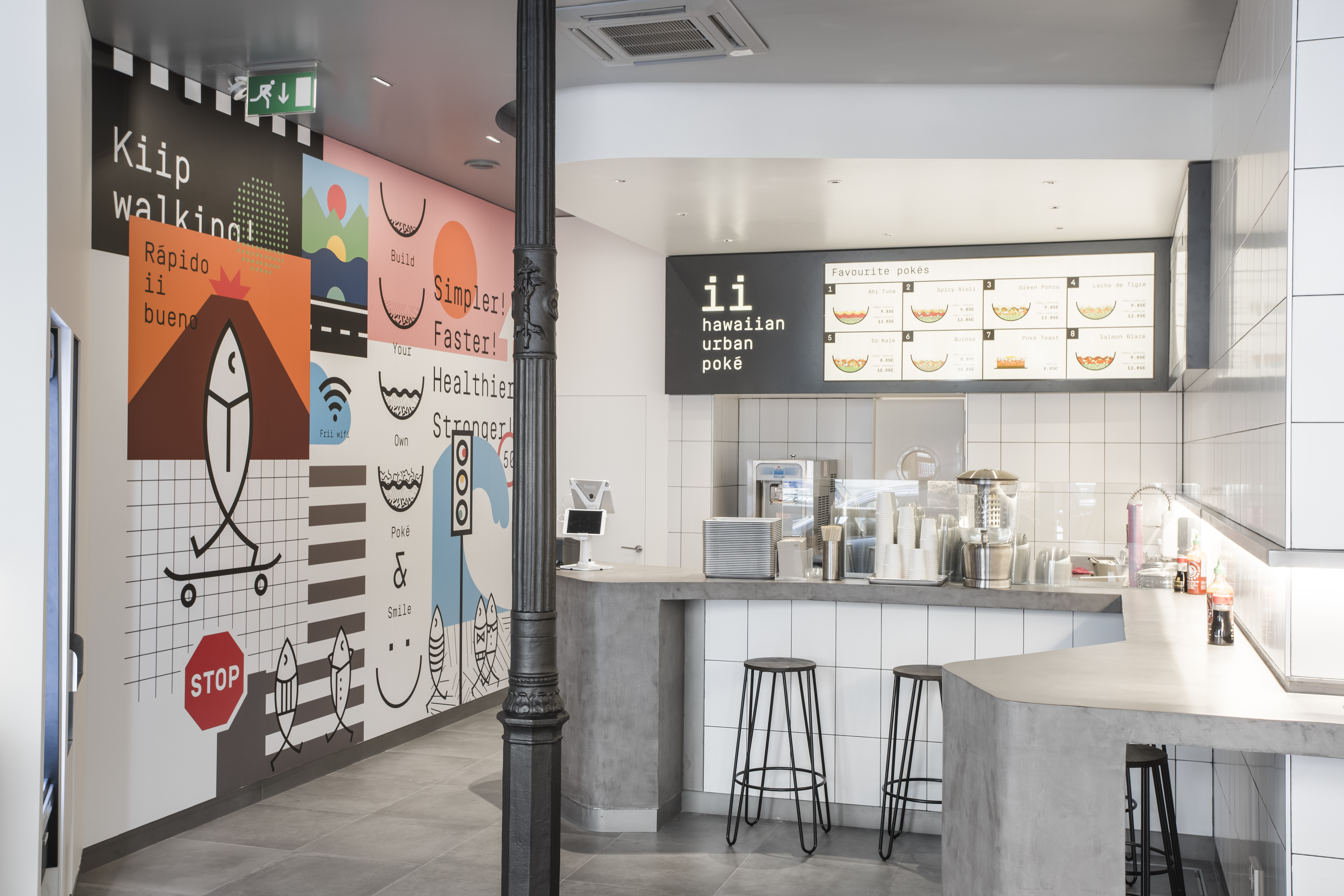 Modern concrete-look floor tiles and white wall tiles in an urban restaurant.