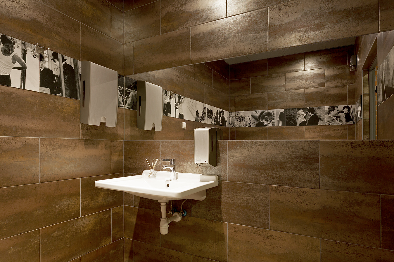 Modern bathroom with high-quality brown wall tiles and vanity unit.
