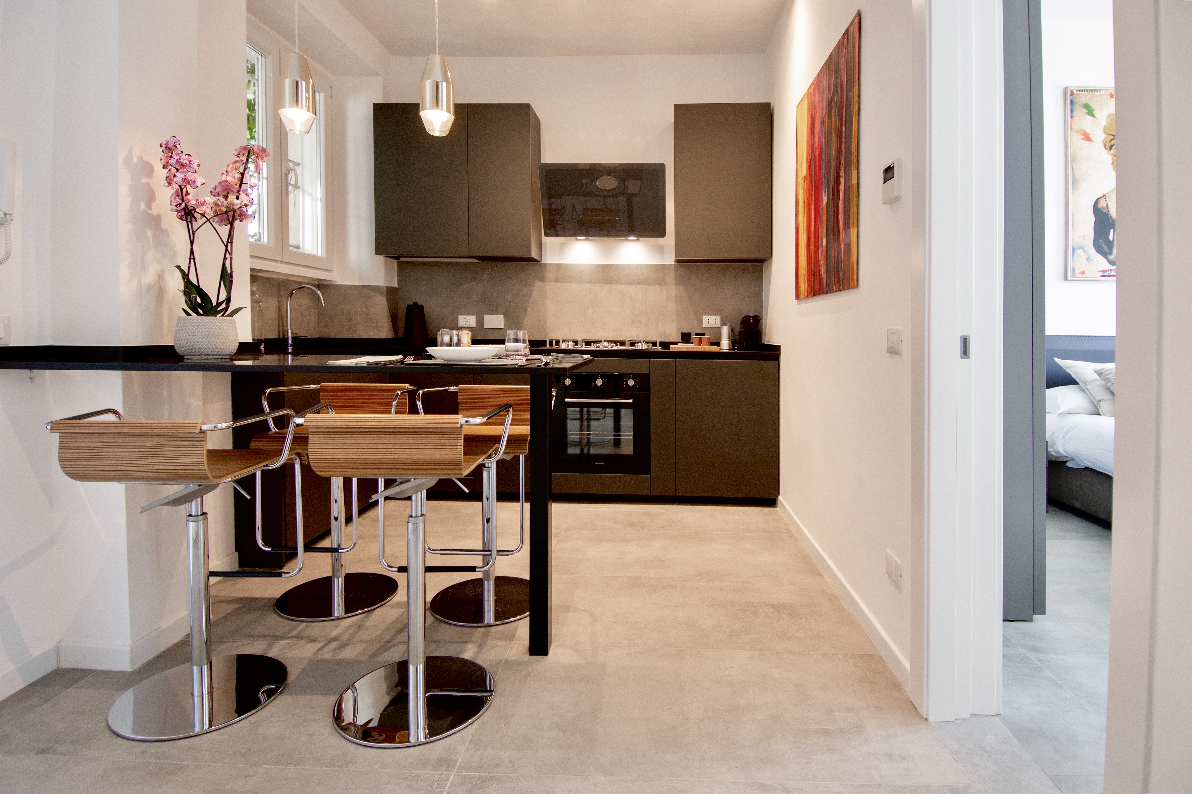 Modern kitchen with light grey concrete-effect floor tiles, perfect for stylish interiors.