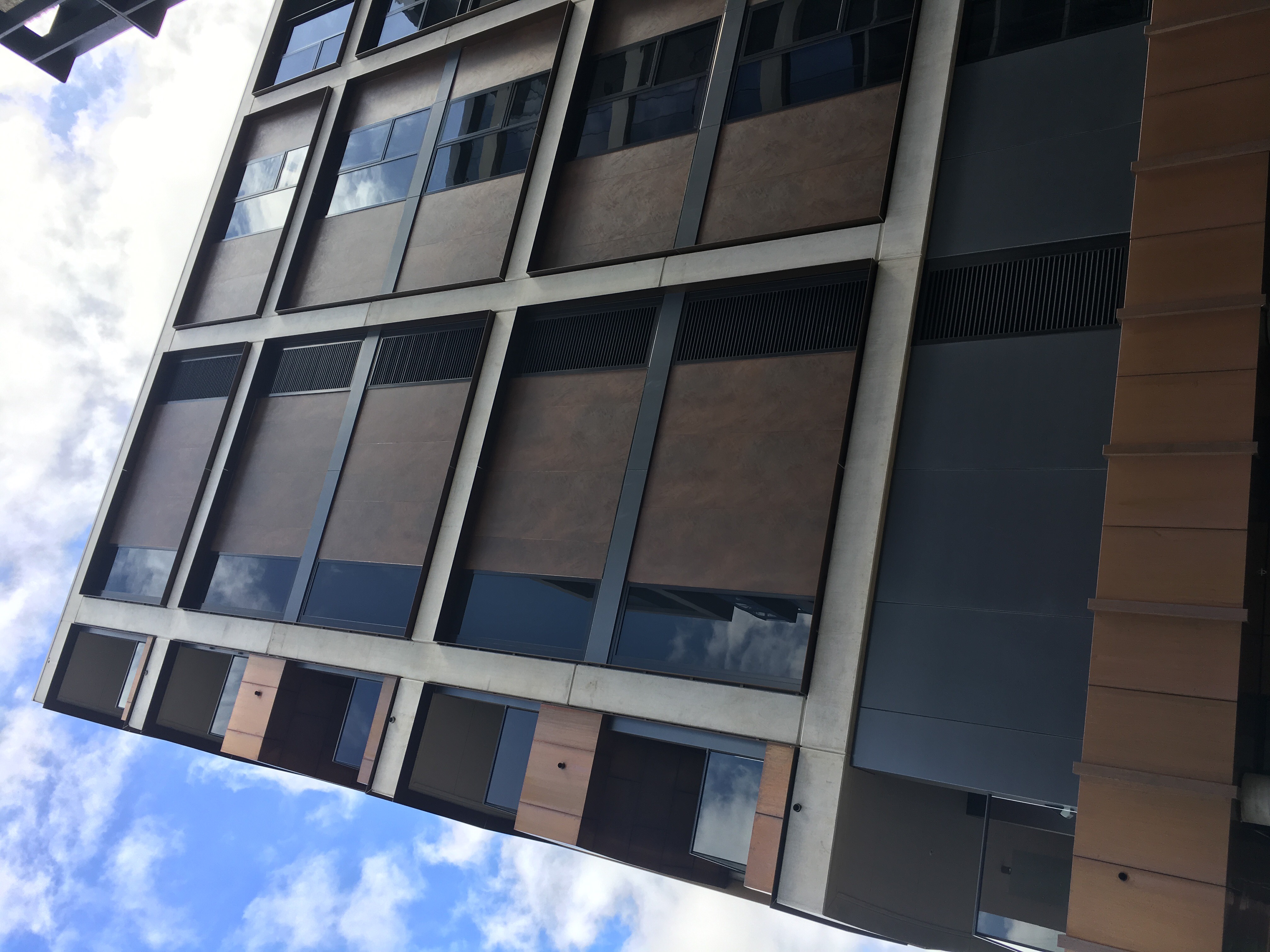 Modern architecture with brown facade tiles and concrete elements.