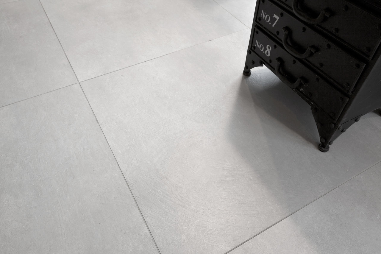 Light, large-format cement-look floor tiles.