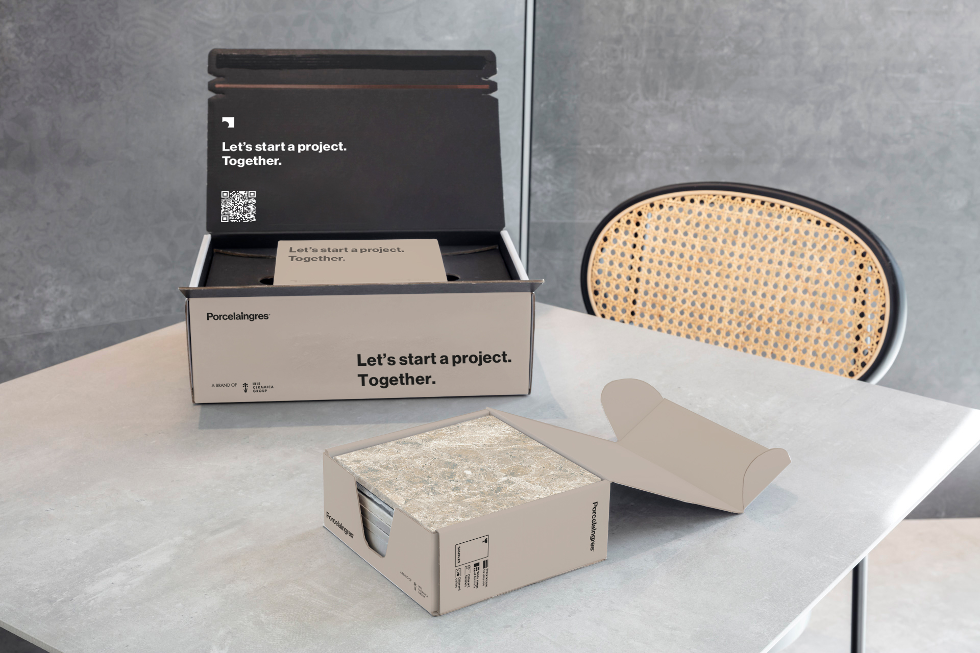 Porcelaingres project box and tile samples on a modern table.