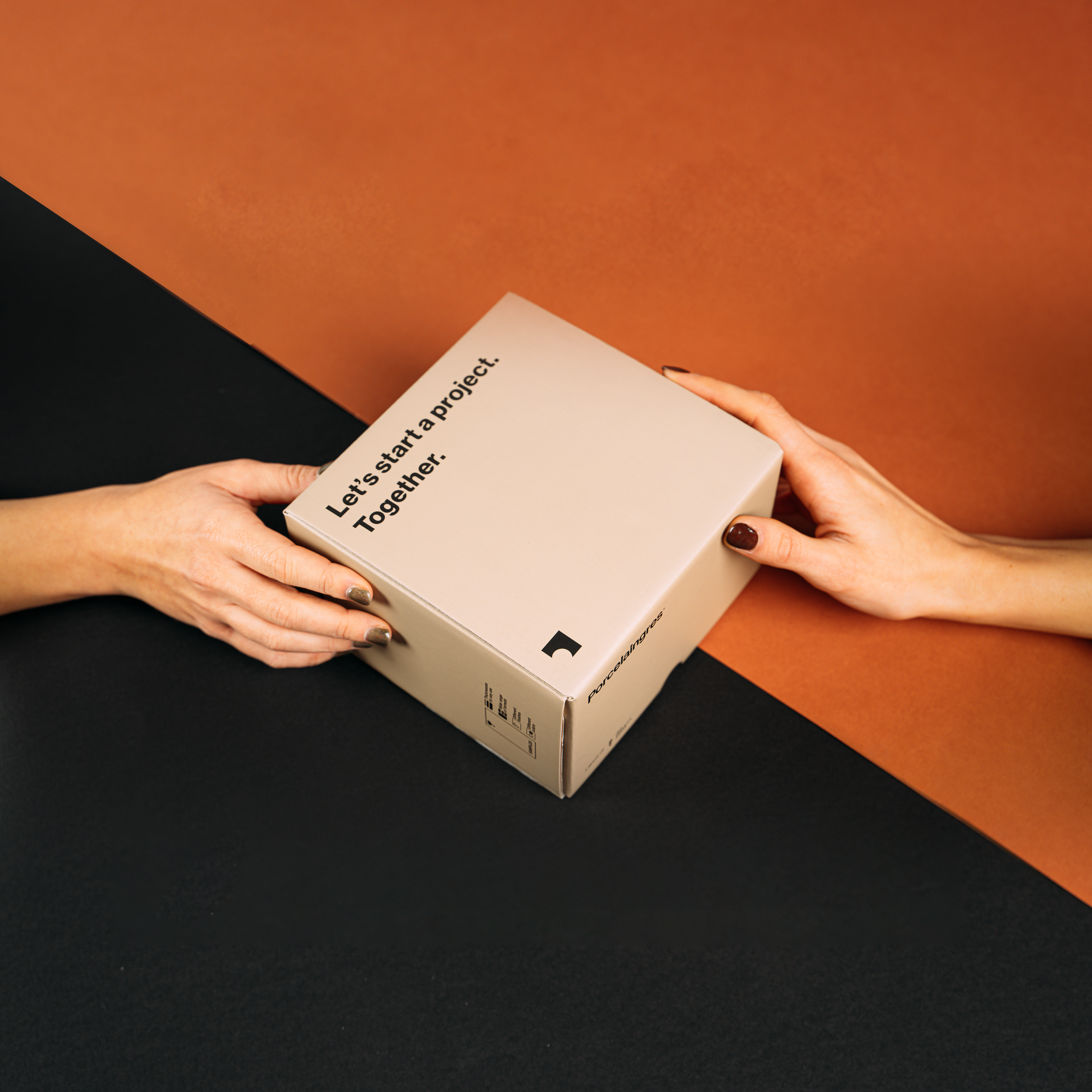 Kick-start your tile project: Hands holding a box with an inspiring message.