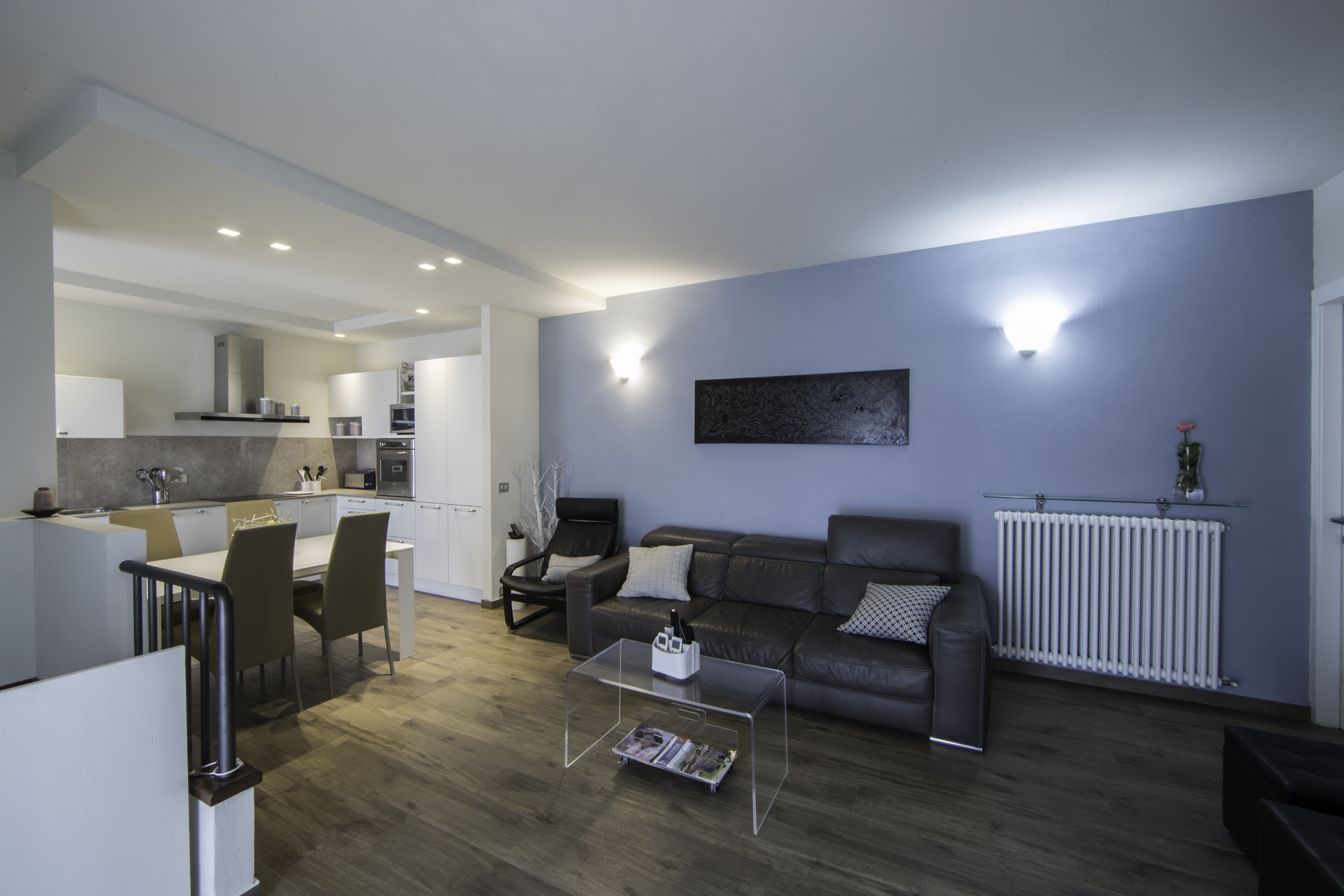 High-quality wood-effect tiles in an open-plan living area with a blue wall.