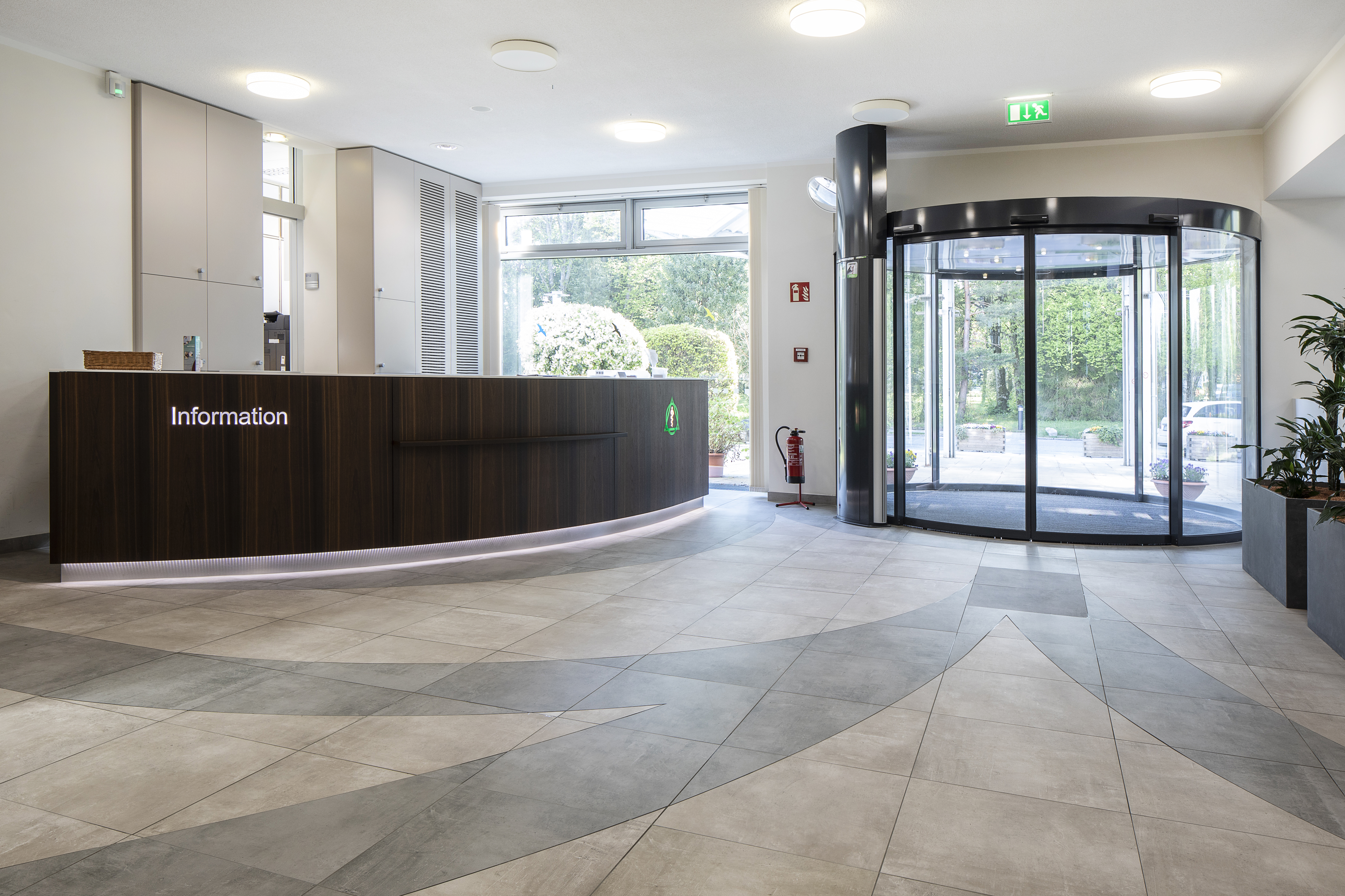 Bright reception area with stylish tiled floor and desk.