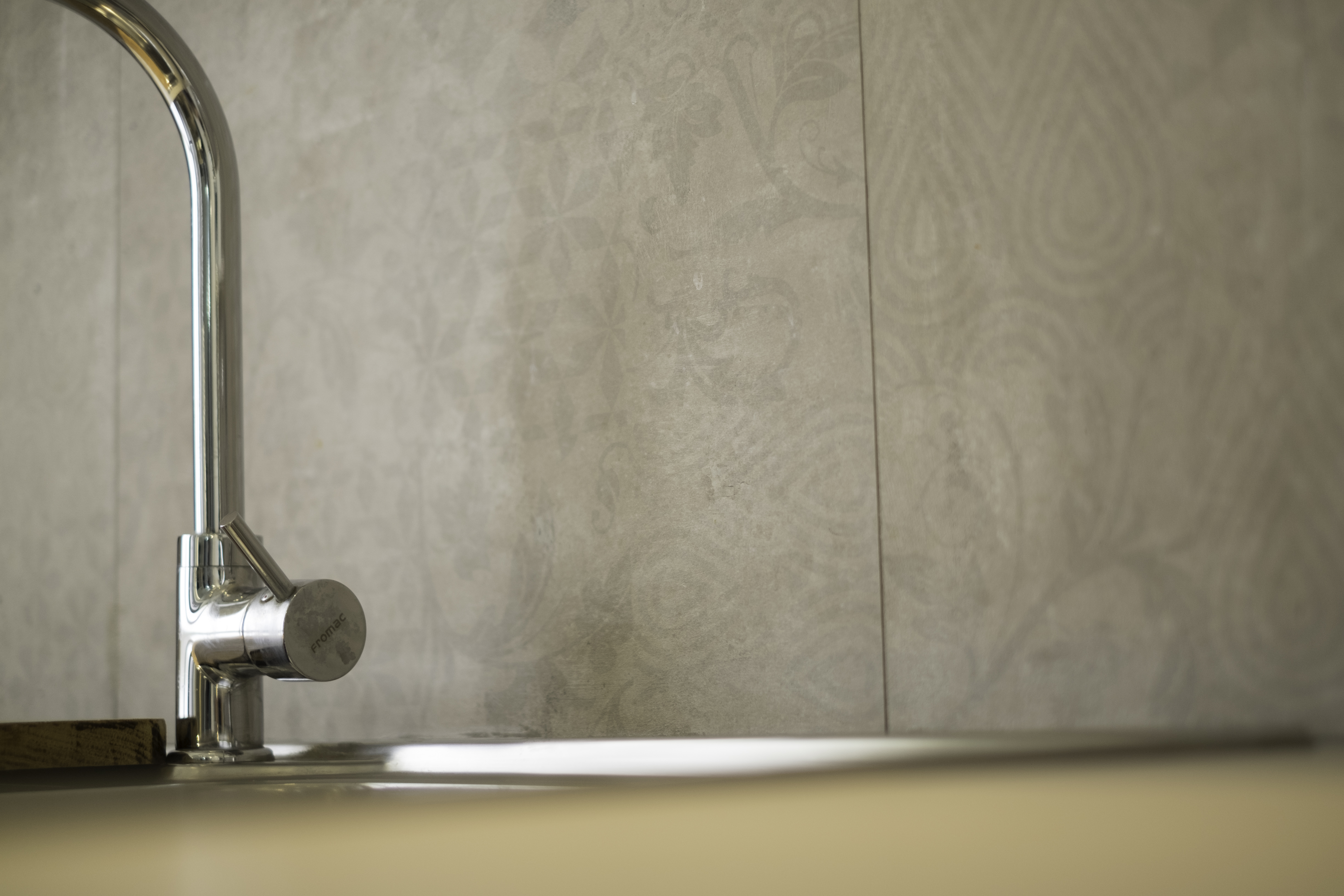 Elegant grey wall tiles with subtle texture for bathroom or kitchen.
