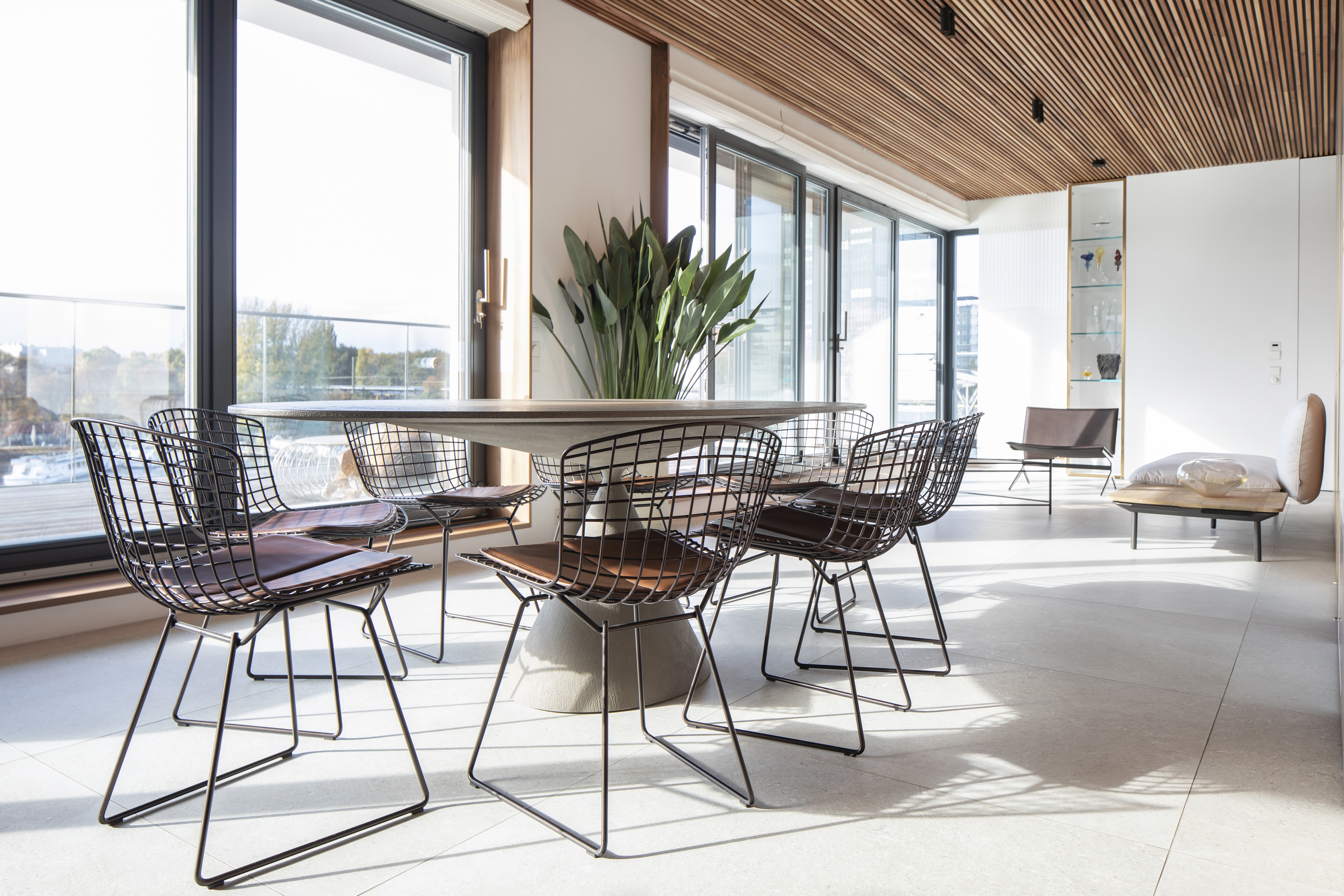 Bright, large-format tiles in a modern dining and living area.