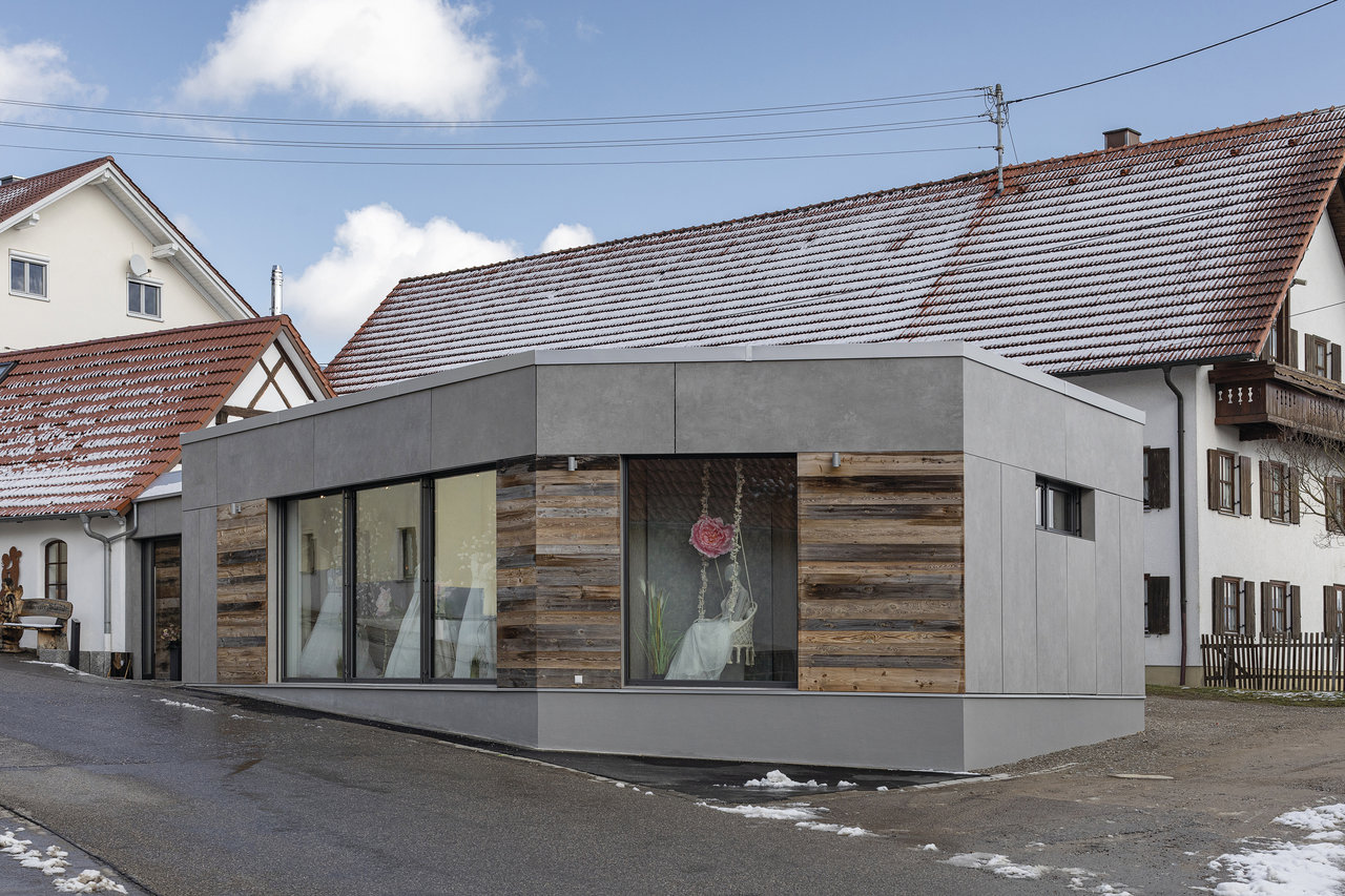 Modern building with grey facade and wood cladding, matching high-quality tiles.