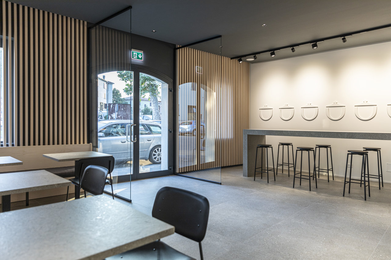 Elegant interior with large-format concrete-look tiles and wooden slats.