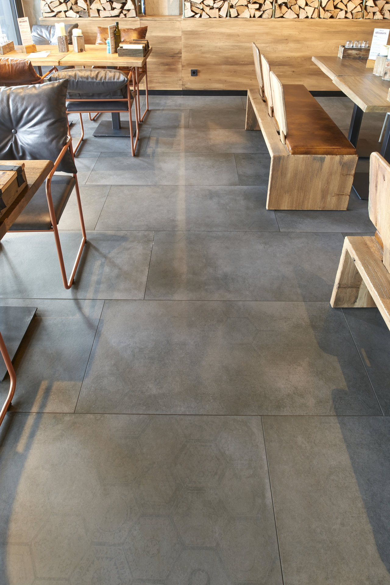 Large-format, anthracite concrete-effect tiles with subtle pattern for modern settings.