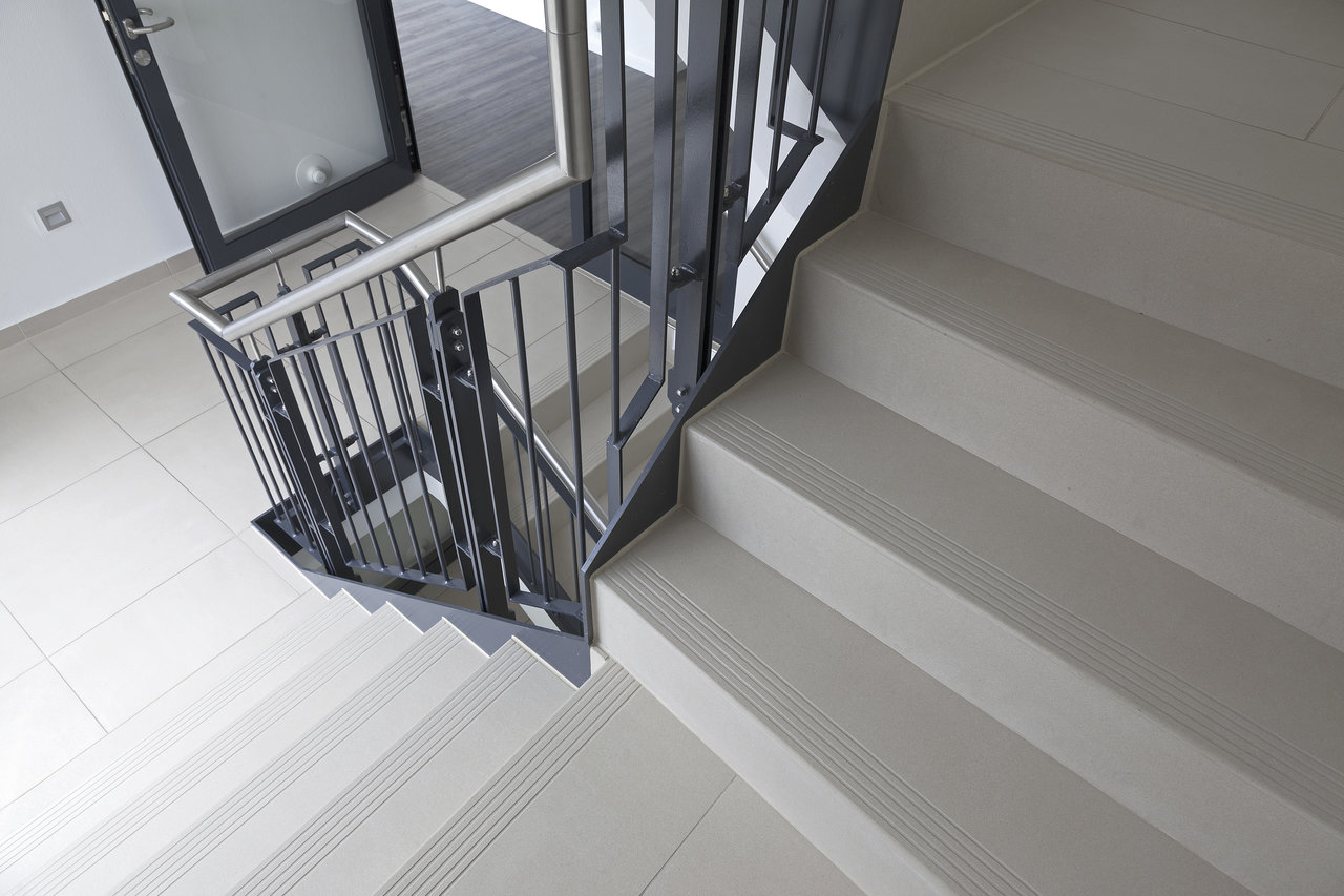 High-quality light grey stair tiles with anti-slip grooves for secure grip.