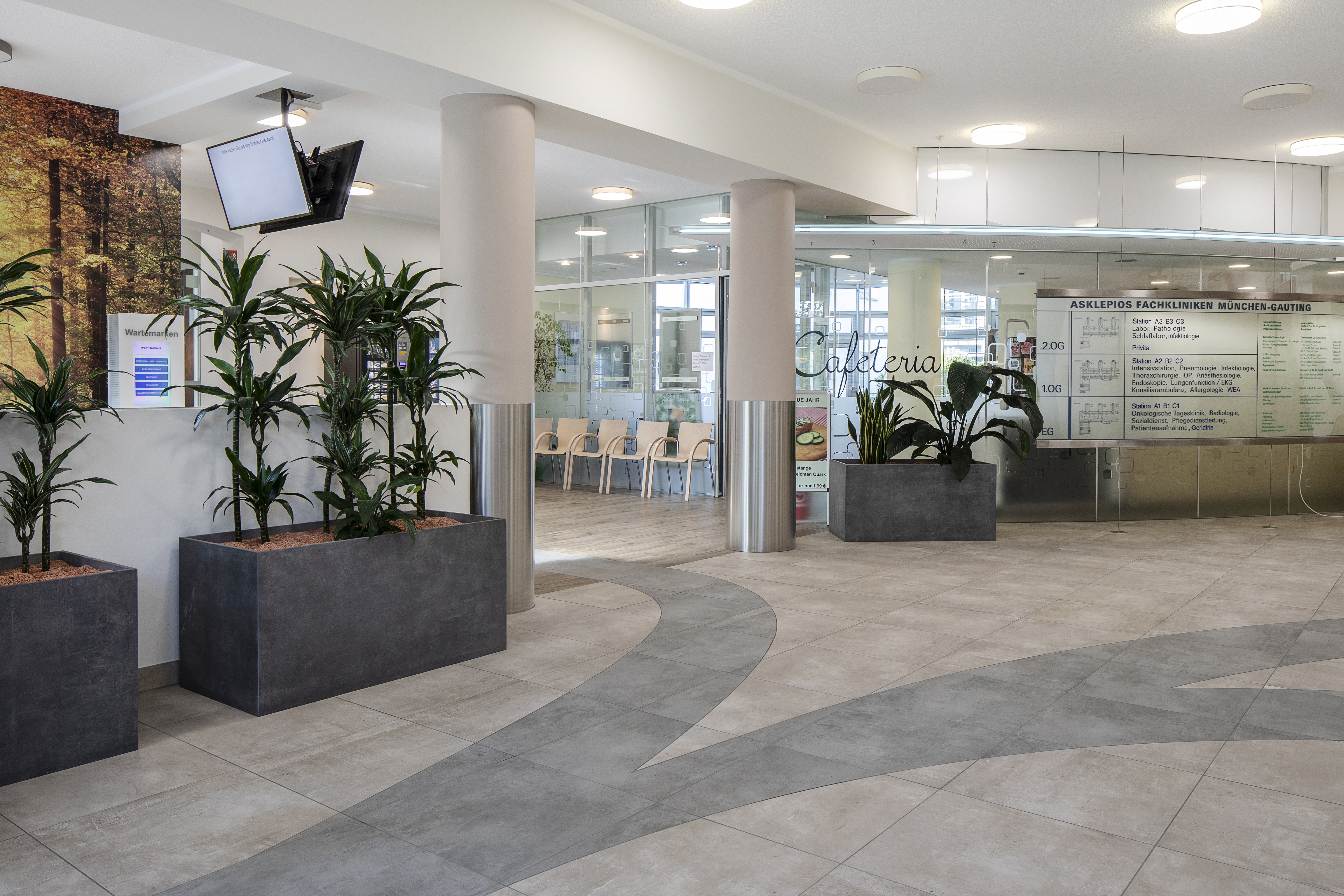 Spacious foyer with modern grey floor tiles and a curved pattern.
