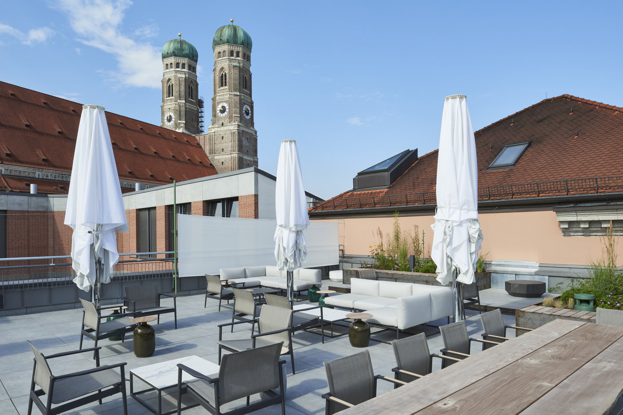 Modern rooftop terrace with high-quality outdoor tiles and lounge furniture.