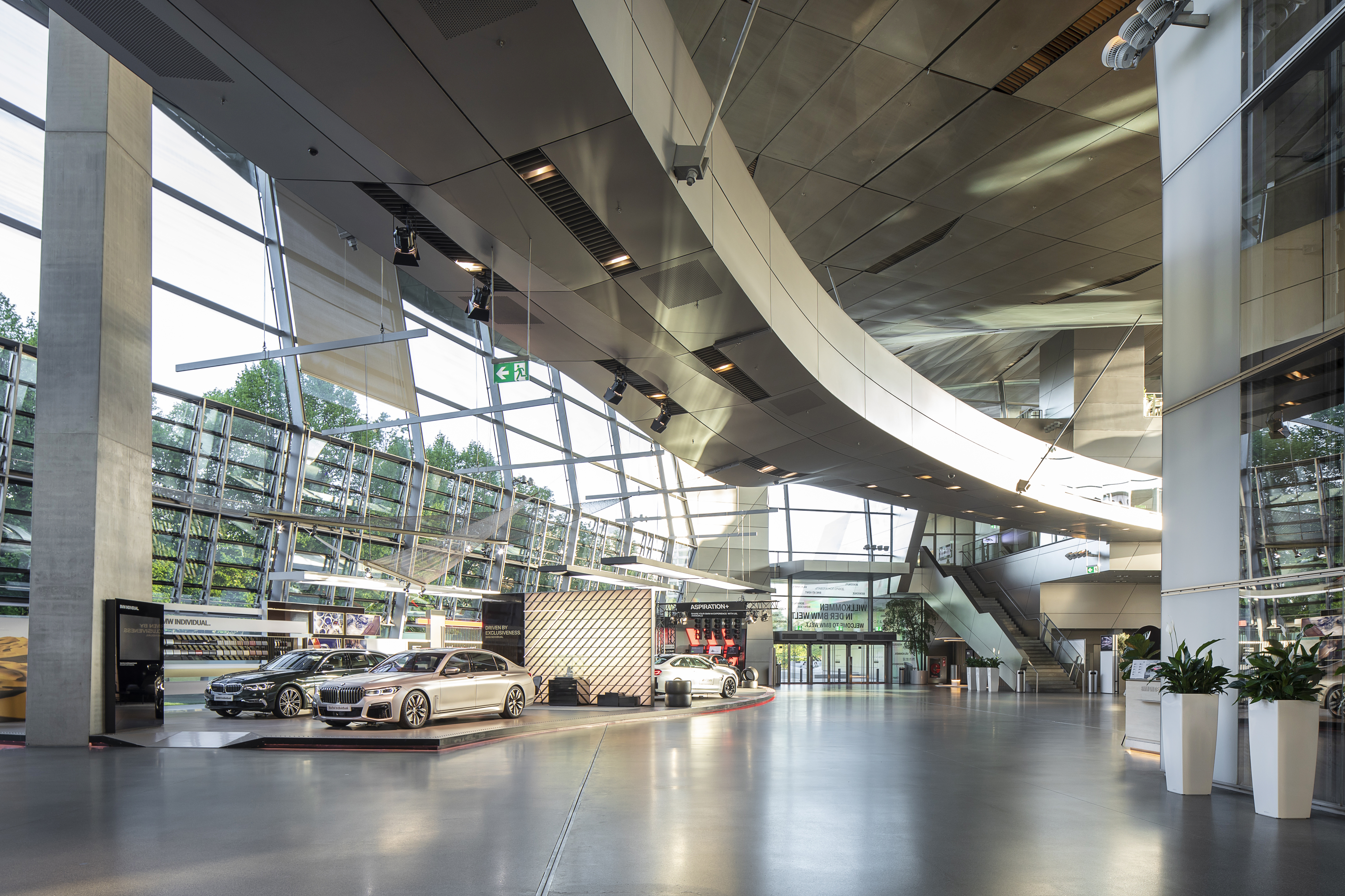 Elegant showroom with bright, large-format tiled floor and modern vehicles.