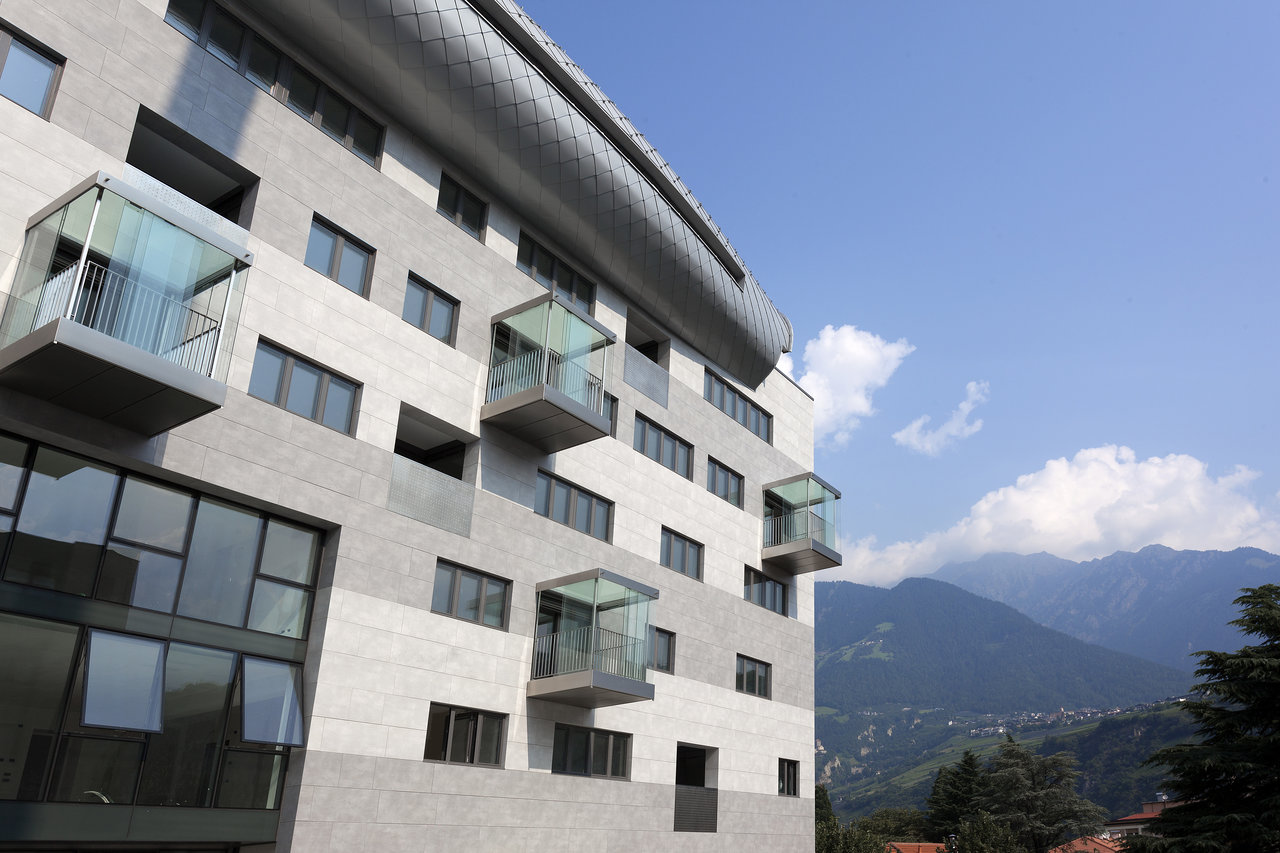 Elegant tile facade on a modern building with mountain view.