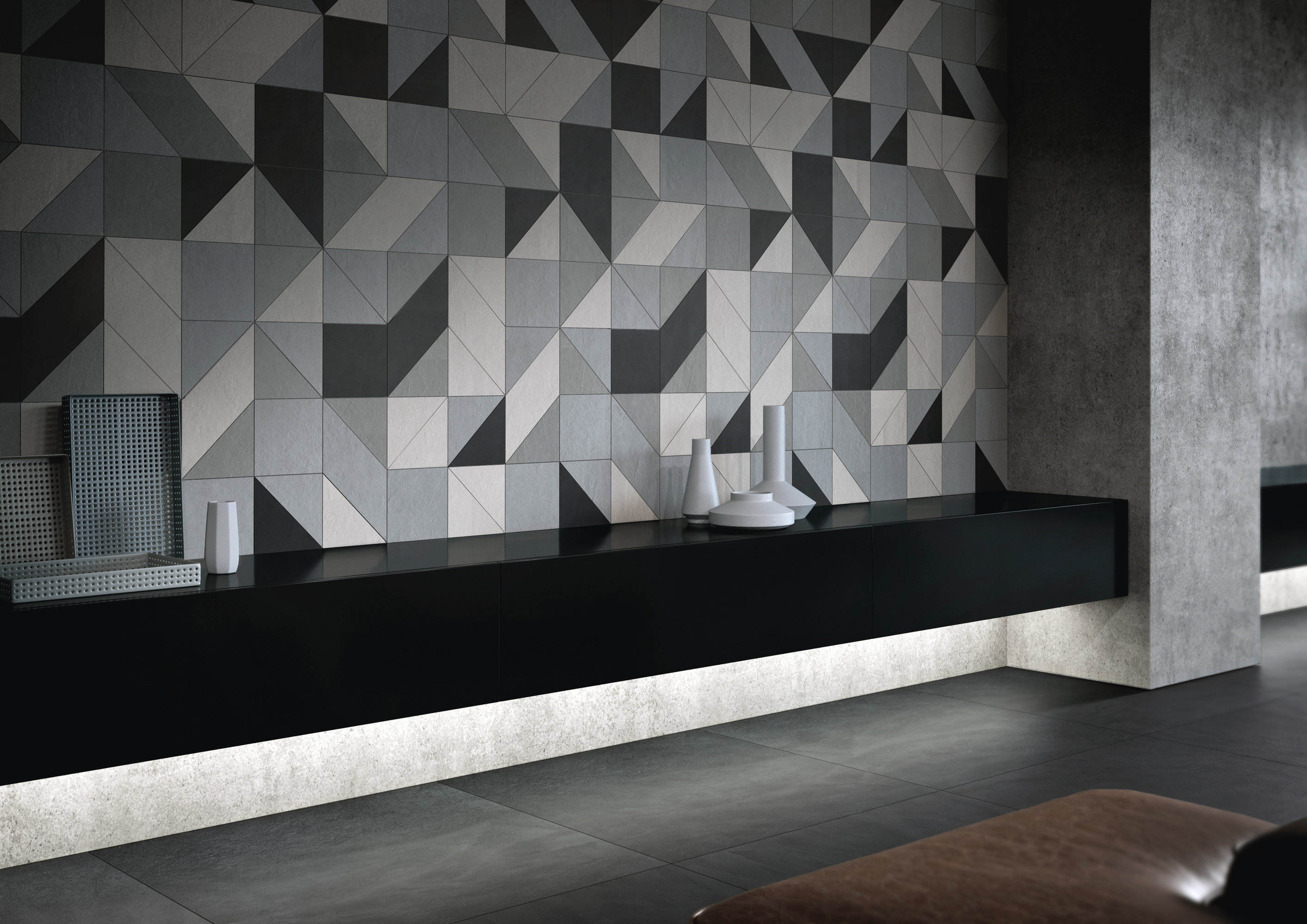 Designer wall tiles with geometric pattern in grey and black tones.