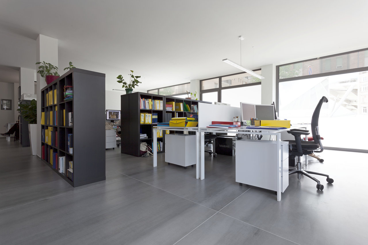 Spacious office with modern, high-quality light-grey floor tiles.