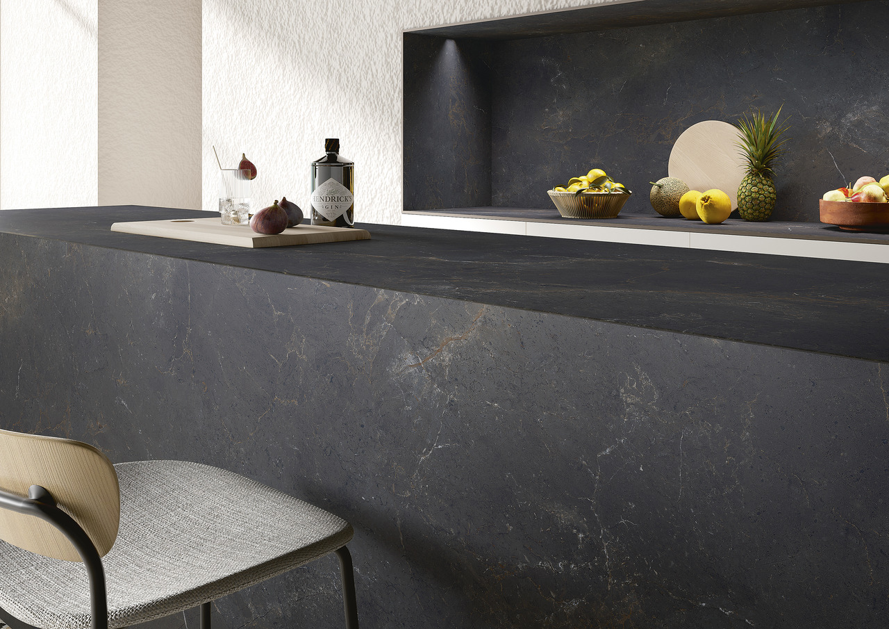 Dark, textured tiles as modern kitchen worktop & wall cladding.